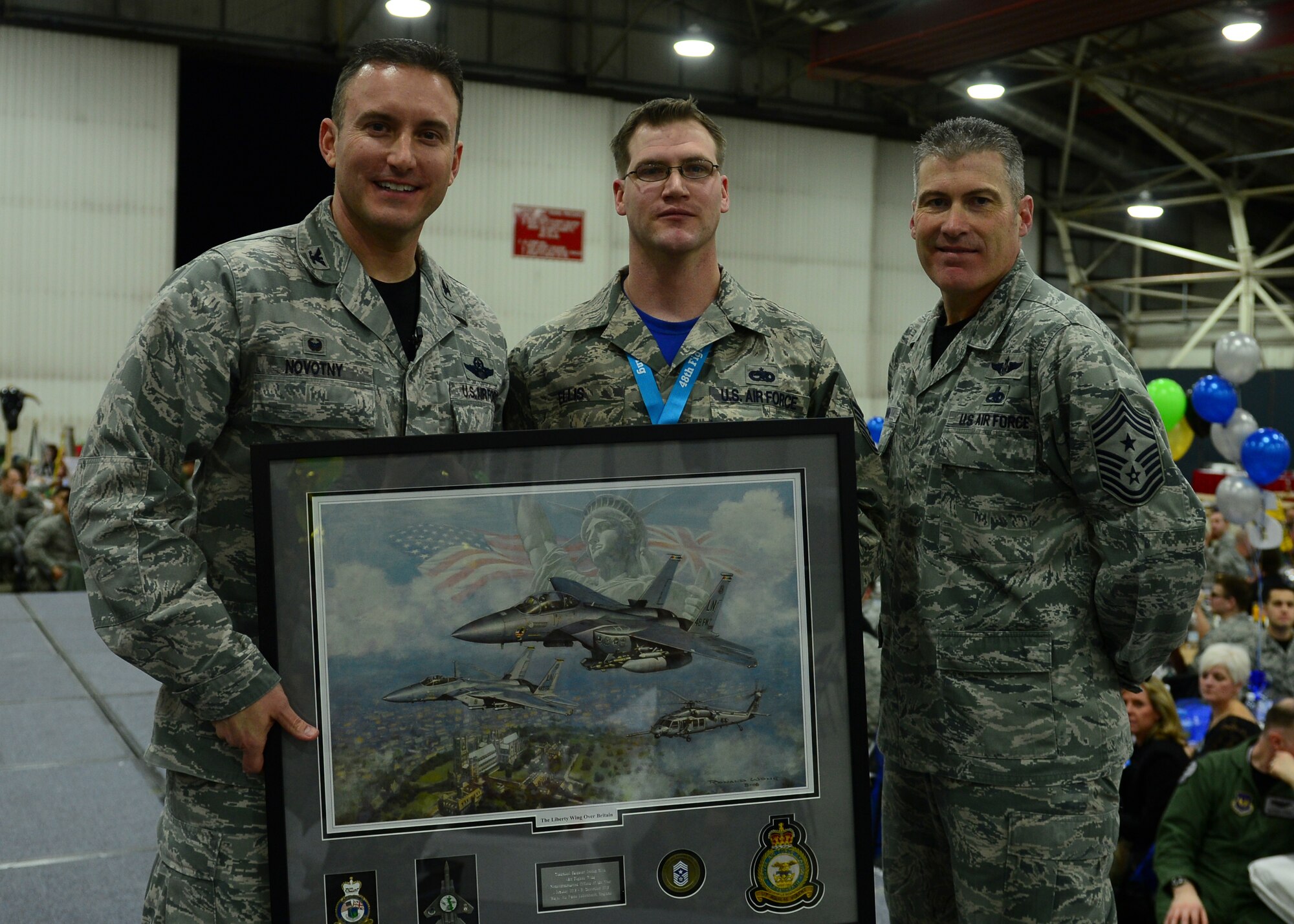 ¬¬¬Col. Robert Novotny, 48th Fighter Wing commander, and Chief Master Sgt. David O’Hara, 48th Fighter Wing command chief, present the NCO of the Year Award to Tech Sgt. Jordan Ellis, 48th Maintenance Group, during the 48th FW Annual Awards Banquet at Hangar 7, Feb. 5, 2016. Airmen were recognized across 13 categories, representing the spectrum of the Liberty Wing. (U.S. Air Force photo by Senior Airman Dawn M. Weber)

