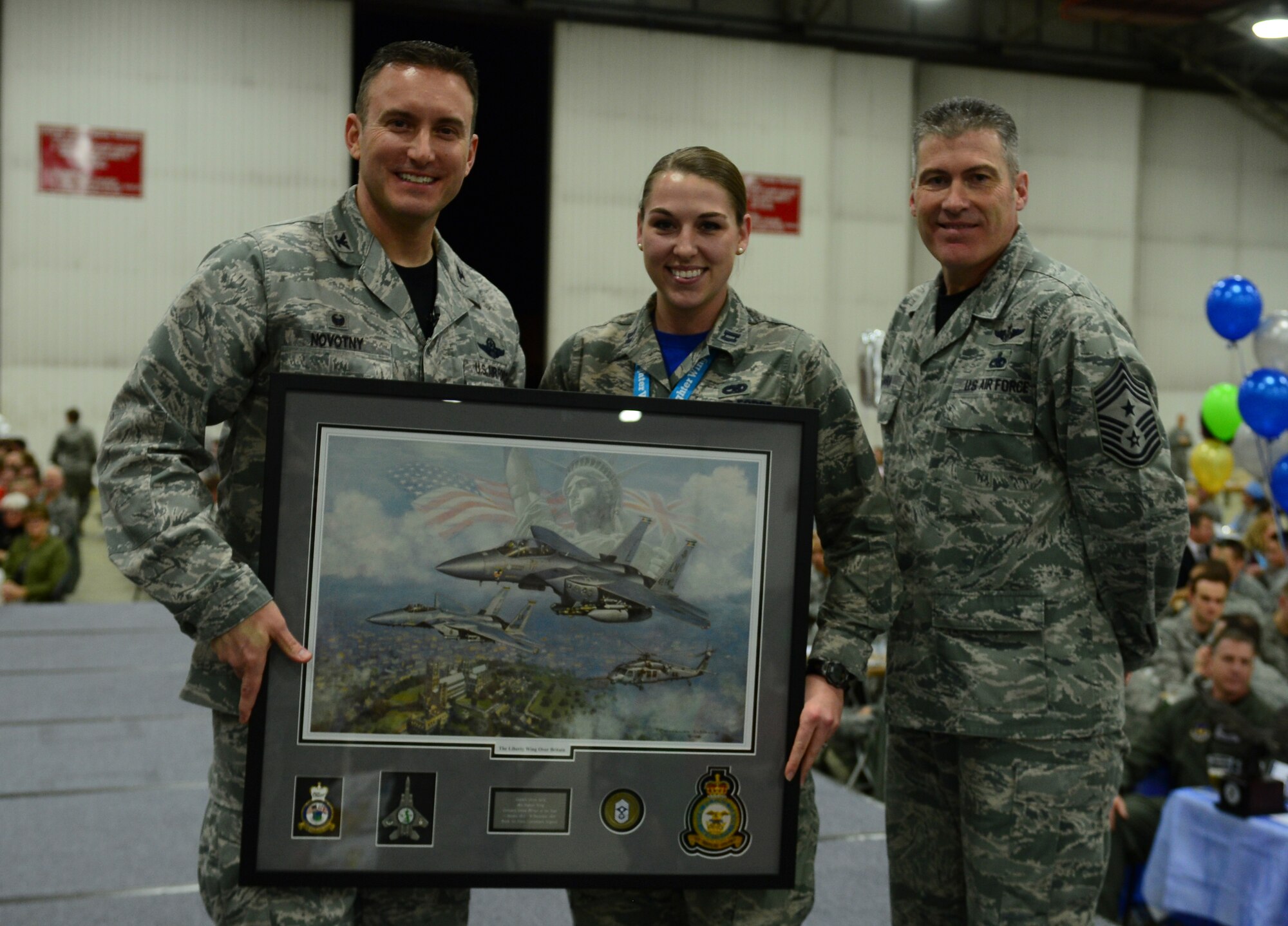Col. Robert Novotny, 48th Fighter Wing commander, and Chief Master Sgt. David O’Hara, 48th Fighter Wing command chief, present the Company Grade Officer of the Year Award to Capt. Olivia Mills, 48th Maintenance Group, during the 48th FW Annual Awards Banquet at Hangar 7, Feb. 5, 2016. Airmen were recognized across 13 categories, representing the spectrum of the Liberty Wing. (U.S. Air Force photo by Senior Airman Dawn M. Weber)