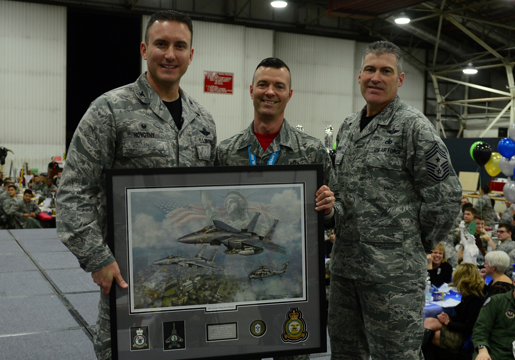 Col. Robert Novotny, 48th Fighter Wing commander, and Chief Master Sgt. David O’Hara, 48th Fighter Wing command chief, present the First Sergeant of the Year Award to Senior Master Sgt. Nick Kurpier, 48th Maintenance Group, during the 48th FW Annual Awards Banquet at Hangar 7, Feb. 5, 2016. Airmen were recognized across 13 categories, representing the spectrum of the Liberty Wing. (U.S. Air Force photo by Senior Airman Dawn Weber)