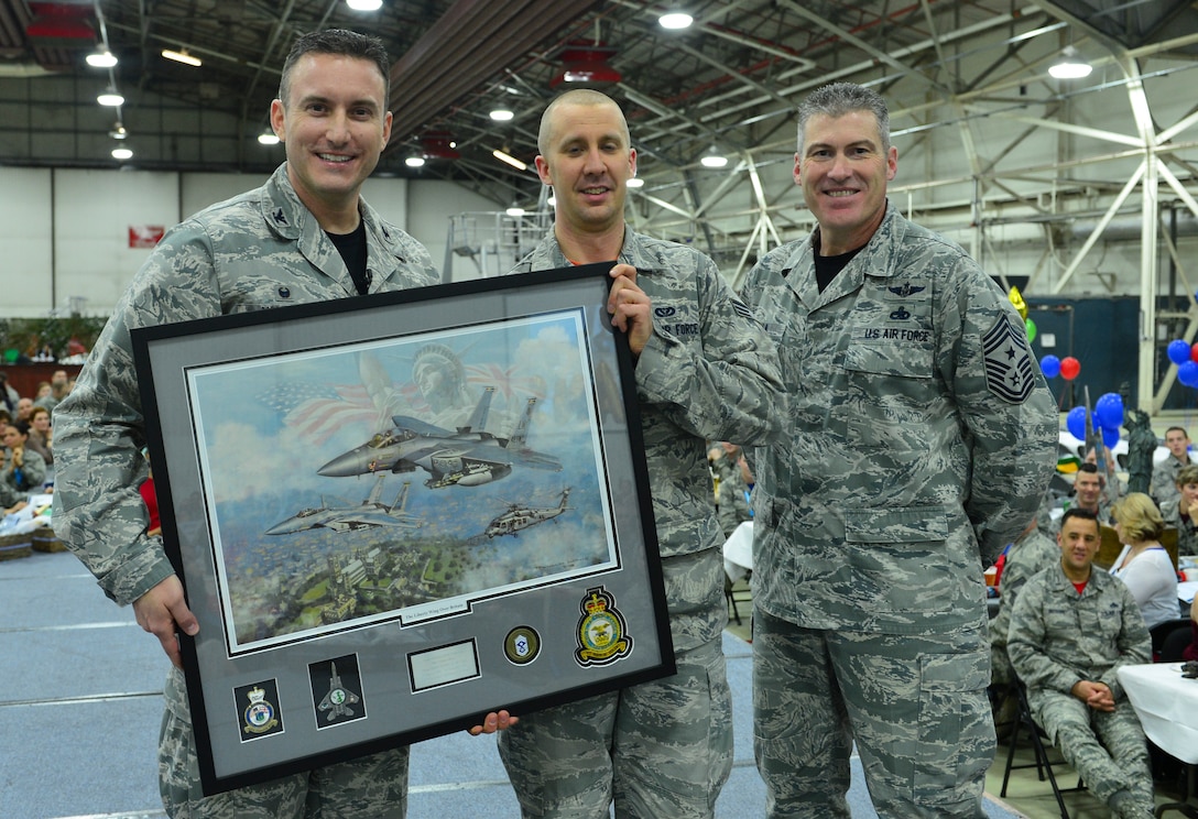 Col. Robert Novotny, 48th Fighter Wing commander, and Chief Master Sgt. David O’Hara, 48th Fighter Wing command chief, present the Honor Guard Member of the Year Award to Senior Airman David Anderson, 48th Mission Support Group, during the 48th FW Annual Awards Banquet at Hangar 7, Feb. 5, 2016. Airmen were recognized across 13 categories, representing the spectrum of the Liberty Wing. (U.S. Air Force photo by Staff Sgt. Stephanie Longoria)
