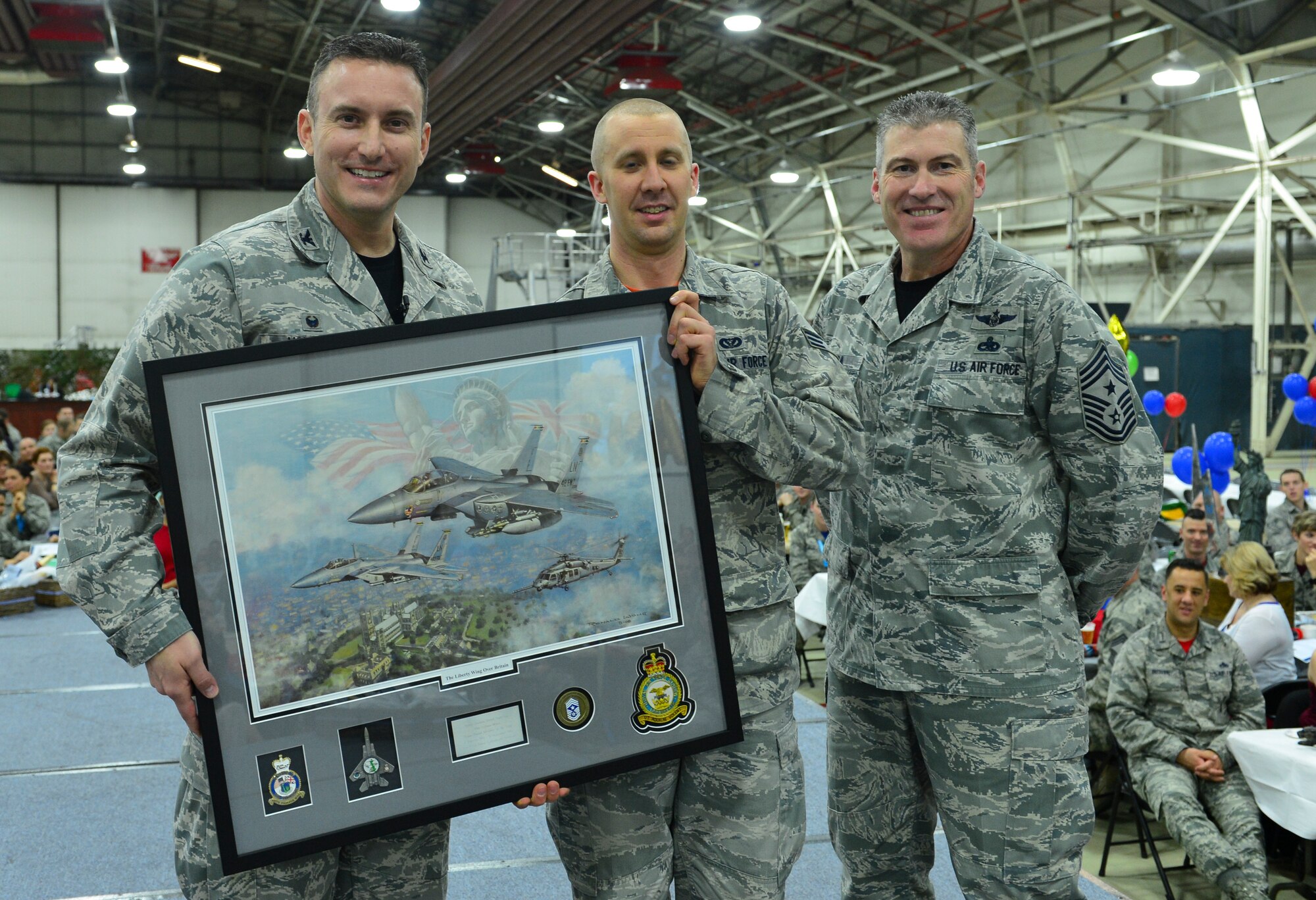 Col. Robert Novotny, 48th Fighter Wing commander, and Chief Master Sgt. David O’Hara, 48th Fighter Wing command chief, present the Honor Guard Member of the Year Award to Senior Airman David Anderson, 48th Mission Support Group, during the 48th FW Annual Awards Banquet at Hangar 7, Feb. 5, 2016. Airmen were recognized across 13 categories, representing the spectrum of the Liberty Wing. (U.S. Air Force photo by Staff Sgt. Stephanie Longoria)
