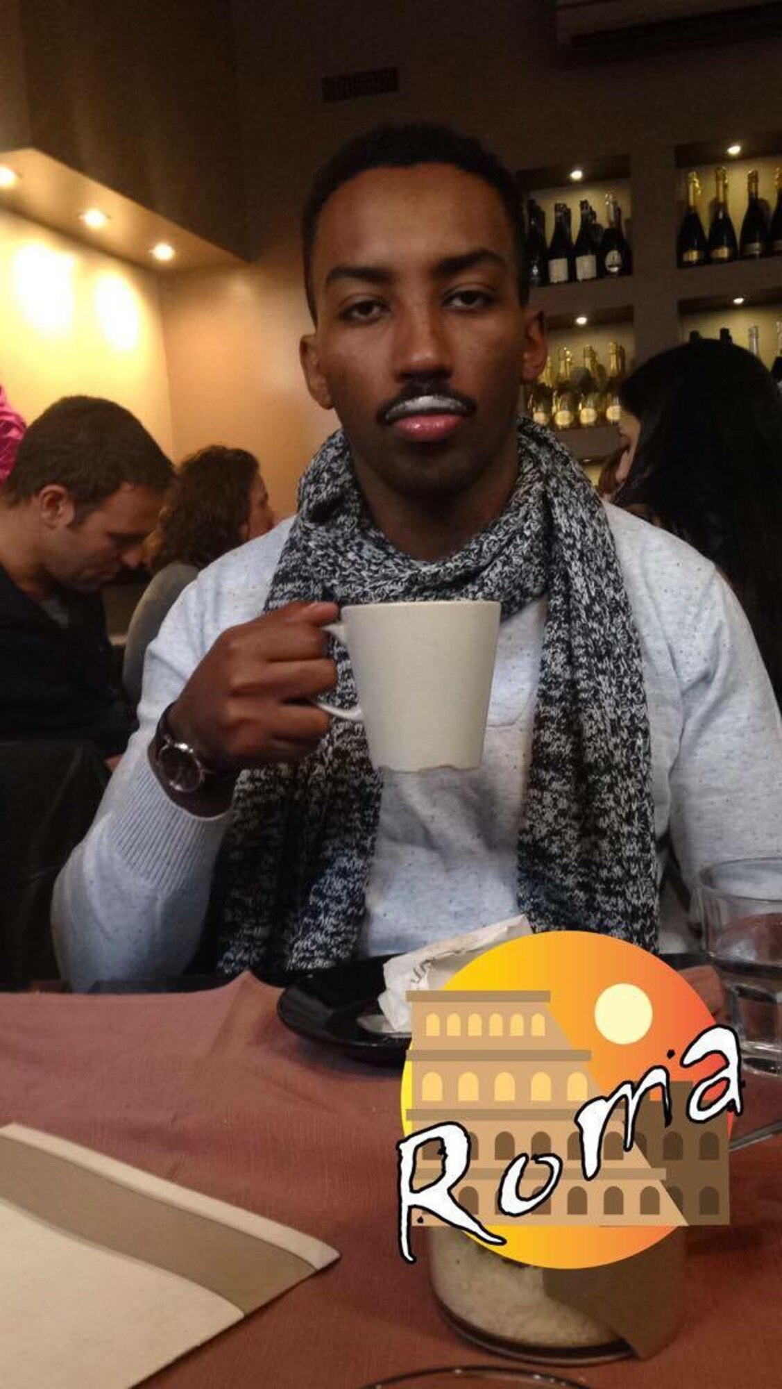 Staff Sgt. Liban Kano, 48th Force Support Squadron career development supervisor, sips coffee in a café in Rome, Italy. Nov. 2015. Kano travelled to Rome with friends he met at Hill Air Force Base, Utah. (Courtesy photo)