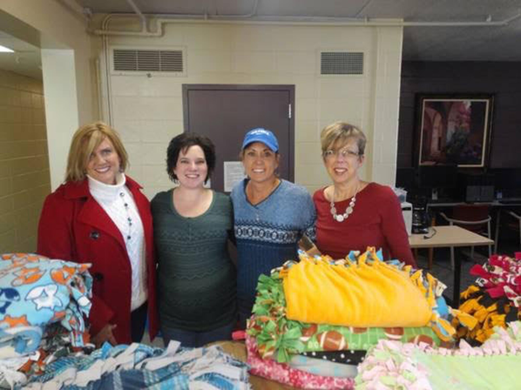 Heather Feighner, installation Military Spouse of the Year award recipient, poses for a photo with other members of the Buckley Spouses Group Dec. 2014 on Buckley Air Force Base, Colo. The award recognizes spouses who excel at contributing and have an unwavering commitment to the military community and country. (Courtesy photo)