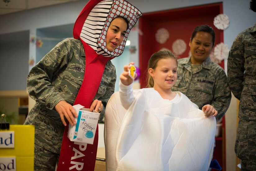 Capt. (Dr.) Melissa Holt, 779th Dental Squadron dentist, and her daughter Samantha, quiz children on healthy and unhealthy foods during a National Children's Dental Health Month event at the Child Development Center at Joint Base Andrews, Md., Feb. 5, 2016. During the event, members from the 779th DS spoke with children about proper brushing techniques, effects of too much sugar and healthy foods. (U.S. Air Force photo by Staff Sgt. Chad C. Strohmeyer/Released)