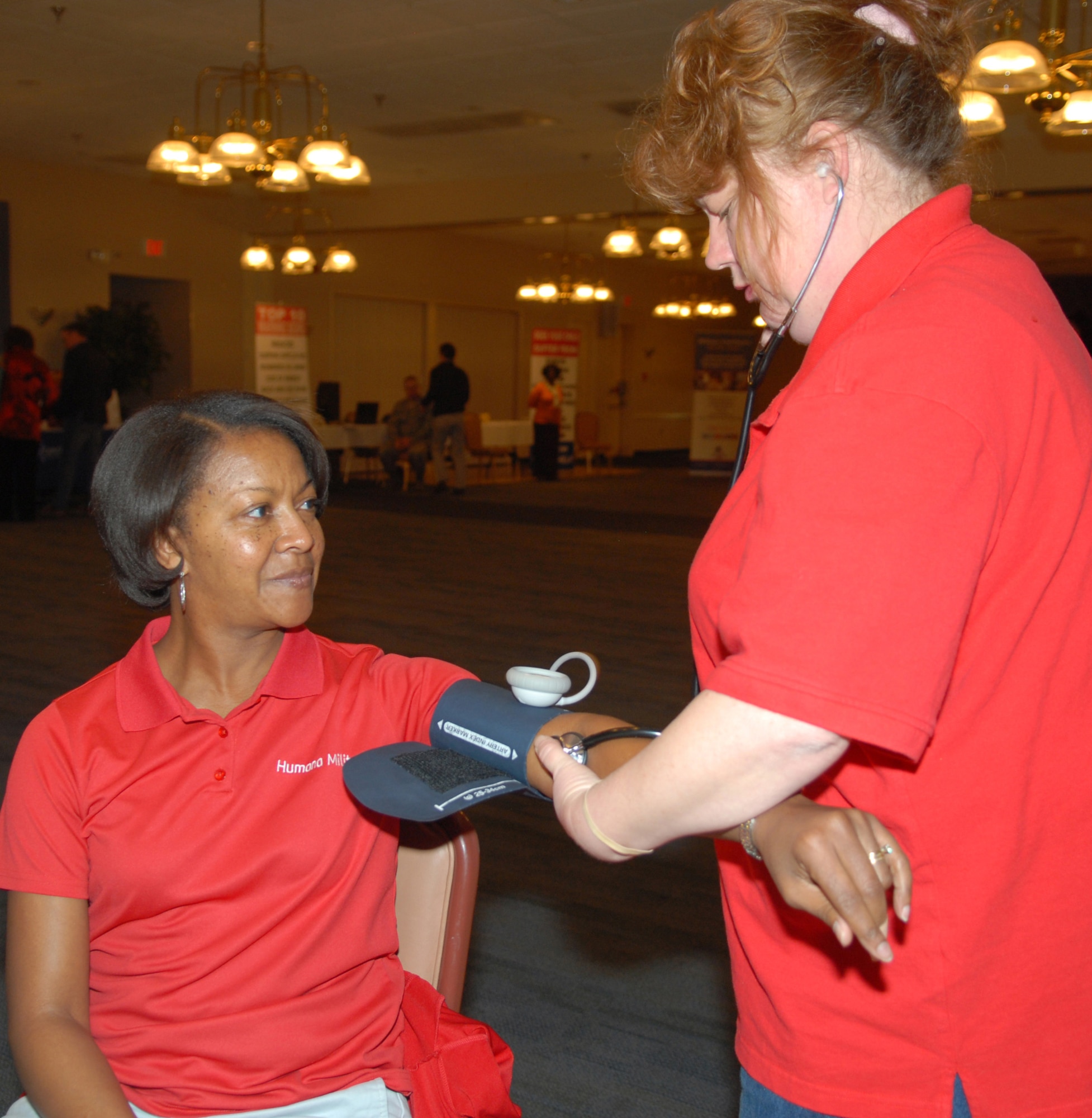 Angela Hawkins, Tricare representative, has her blood pressure checked by Kelley Denny, Civilian Health Promotions Services coordinator, as part of her Cardiac Risk Profile at last
year’s Healthy Heart Fair. February is National Heart Health Month and CHPS will be available at locations base wide throughout the month to answer questions about heart disease and other wellness concerns. (U.S. Air Force photo by Misuzu Allen)