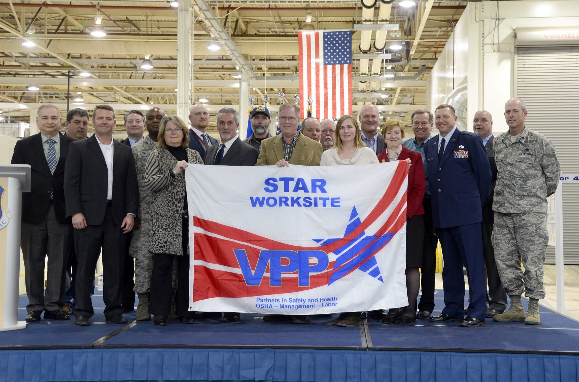 Members of the 76th Commodities Maintenance Group, the 76th Maintenance Support Group and the 76th Propulsion Maintenance Group pose for a photo after the three groups were honored with Voluntary Protection Program Star Status. Pictured are, back row from left, Jimmie “Ty” Norton, American Federation of Government Employees Local 916; David Bates, Occupational Safety and Health Administration area director; Alex McCool, AFGE Local 916; Jim Bligh, AFGE Local 916 vice president; Larry Wood, special government employee, Valero Refinery retired; John Shriver, Valero; middle row from left, Jorge Delucca, OSHA; Col. Robert Jackson, 76th CMXG commander; Rodney Smith, Oklahoma City Air Logistics Complex Safety; Kevin Lassahn, Valero; Mike Maddox, VPPPA president; Carl Dahms, AFGE Local 916 president; front row from left, Johnny VanBuskirk, Valero; Kelley Butler, 76th MXSG director, Gary Bristol, 72nd Air Base Wing Safety; Ericka Ross, AFGE Local 916; Maureen Sullivan, deputy assistant secretary Defense for Environment, Safety and Occupational Health; Brig. Gen. Mark Johnson, OC-ALC commander; and Lt. Col. Mike Allison, 76th PMXG deputy director. See next week’s issue for more coverage. (Air Force photo by Kelly White/Released)
