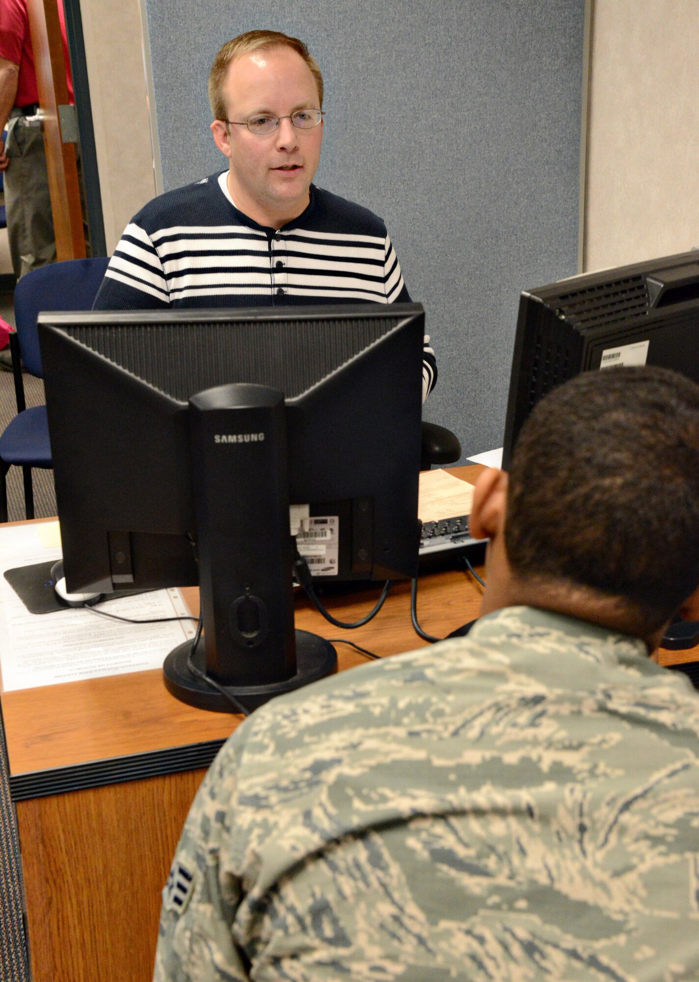 Capt. John Chambers, left, a member of the 964th Airborne Air Control Squadron, is a volunteer at the VITA Office during this tax season. Here, he helps Senior Airman Darnell Ellis, 552nd Maintenance Group, with his 2015 tax return. The VITA office is open Tuesday through Friday from 7:30 to 11 a.m. and noon to 3 p.m. in Bldg. 1. Active duty members of all service branches, retirees, reservists and National Guard members on Title 10 orders are welcome to use their services. The office can be reached at 739-7754 or 739-7792. (Air Force photo by Kelly White/Released)