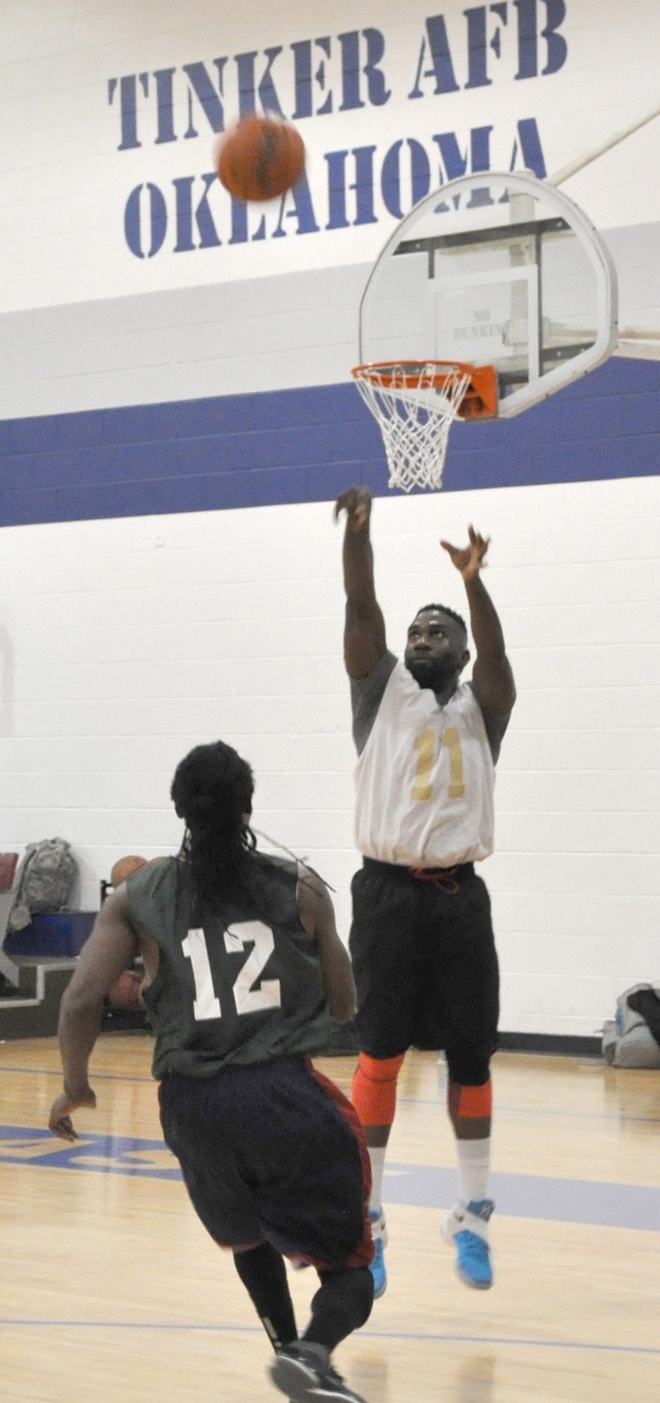 Turn Up’s Toren Carter pops a high floater above the head of Anthony Smith, a Bunch of Losers player, during a Jan. 25 game at the Gerrity Fitness Center. Bunch of Losers triumphed 41-32. (Air Force photo by John Parker/Released)