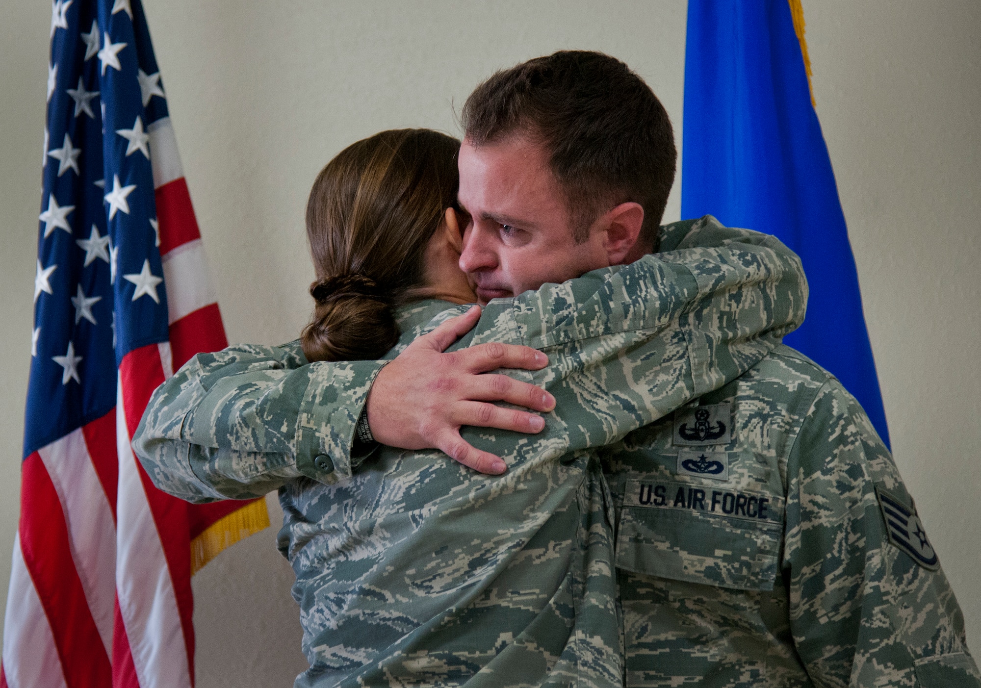 Newly promoted Tech. Sgt. Charles Howell, 96th Civil Engineer Squadron, accepts a congratulatory hug from his spouse, 1st Lt. Megan Howell, 96th Medical Group, after being surprised with an instant Stripes for Exceptional Performers promotion Feb. 4 at Eglin Air Force Base, Fla. Howell, an explosive ordnance disposal technician, was the only recipient this year and the first wing STEP promotee since 2013.  (U.S. Air Force photo/Samuel King Jr.)