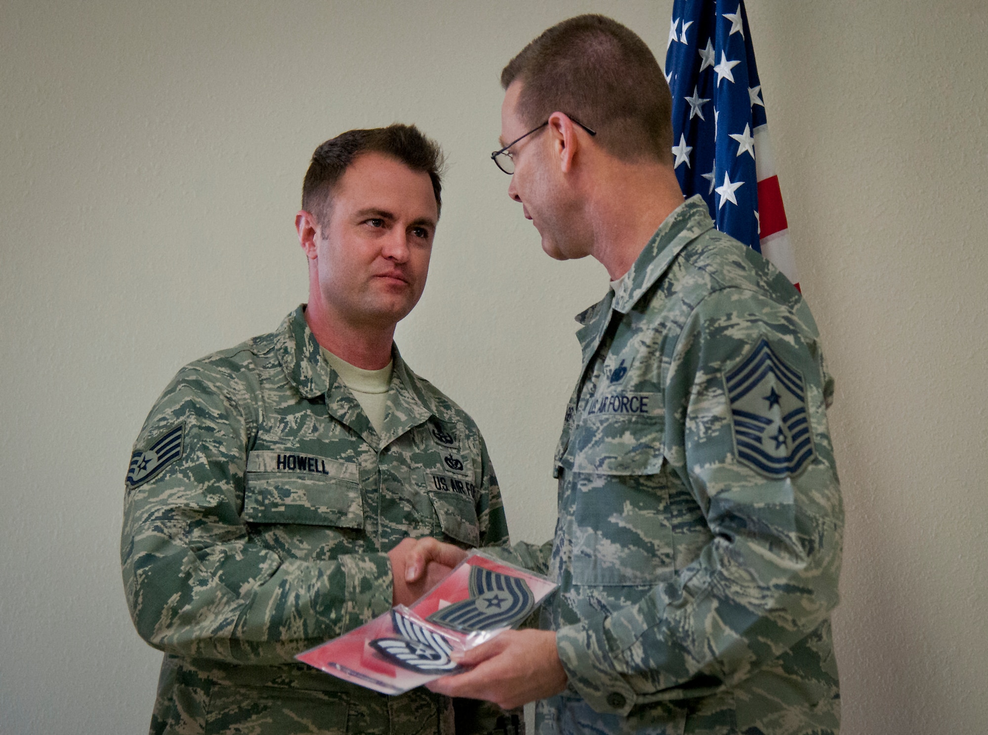 Newly promoted Tech. Sgt. Charles Howell, 96th Civil Engineer Squadron, is informed by Chief Master Sgt. Bryan Creager, 96th Test Wing command chief, he is officially out of uniform Feb. 4 at Eglin Air Force Base, Fla.  Then, the chief gave the Stripes for Exceptional Performers promotee his new stripes.  Howell, an explosive ordnance disposal technician, was the first wing STEP promotee since 2013.  (U.S. Air Force photo/Samuel King Jr.)