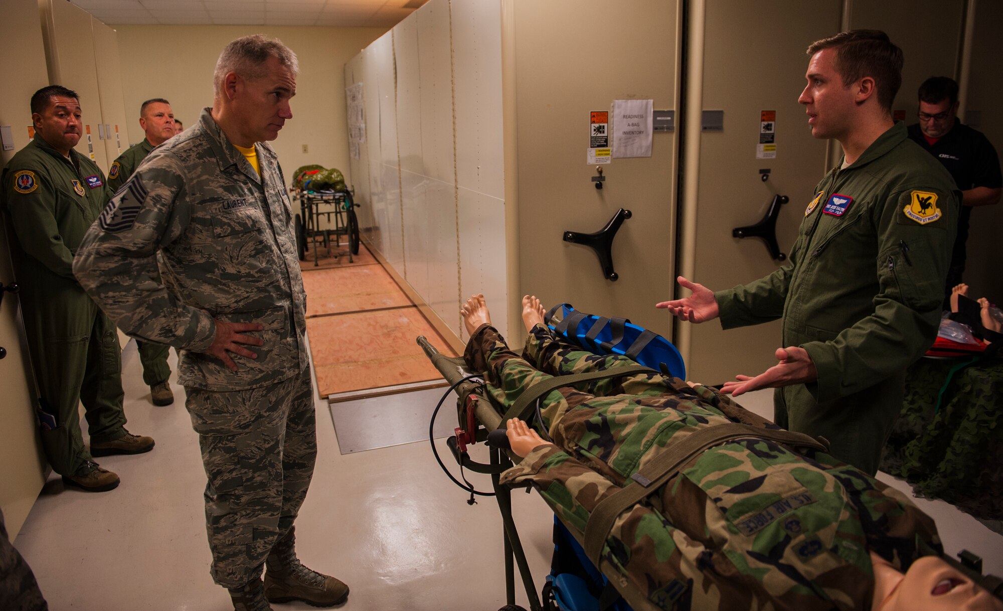 Chief Master Sgt. Jim Laurent, U.S. Forces Japan and 5th Air Force command chief master sgt., and Staff Sgt. Jesse Salter, 18th Aeromedical Evacuation Squadron aeromedical evacuation technician, review transport protocols Feb. 5, 2016, at Kadena Air Base, Japan. Laurent visited various squadrons around Kadena to learn about Airmen’s jobs and commemorated exceptional performers. (U.S. Air Force photo by Airman 1st Class Nick Emerick)