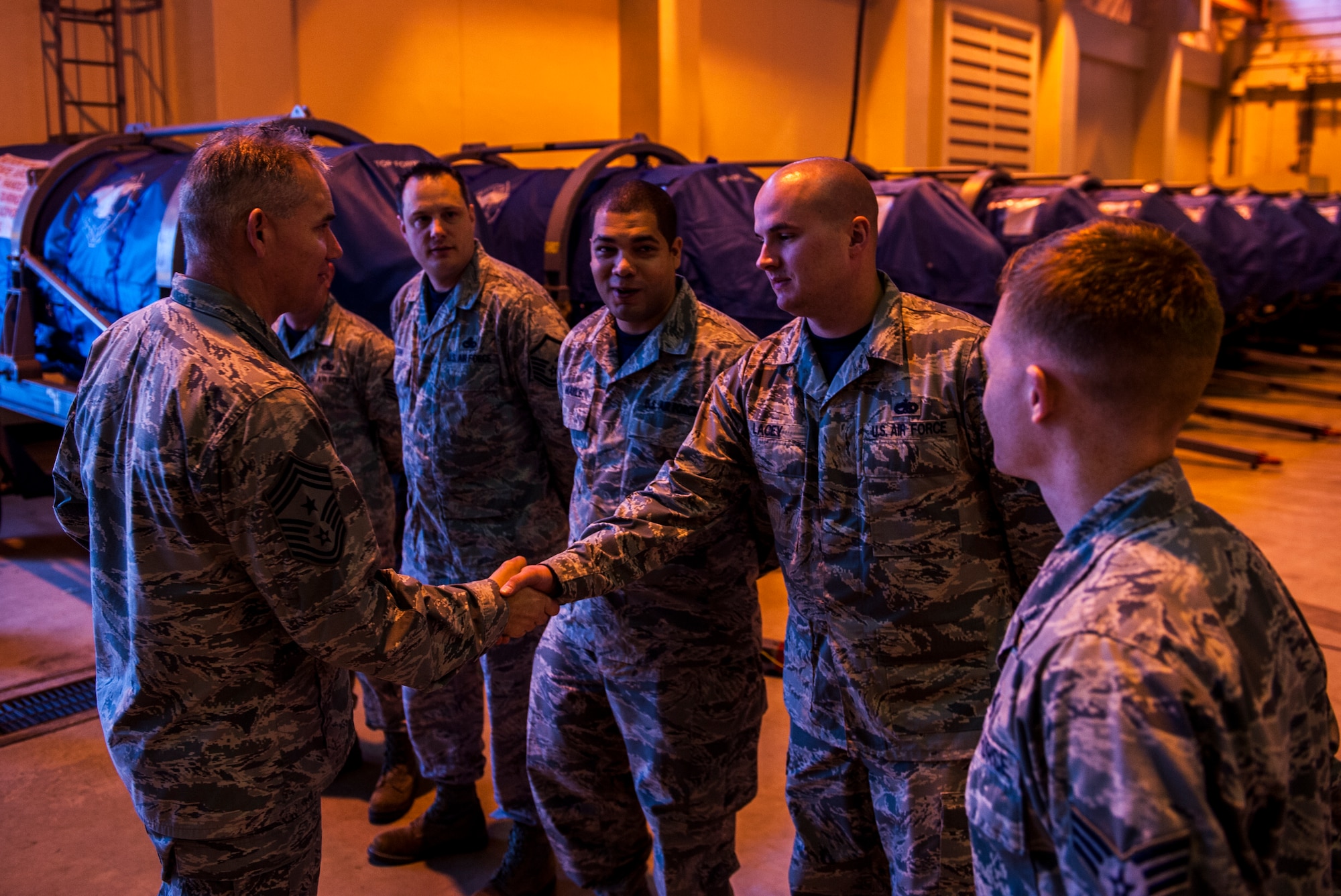 Chief Master Sgt. Jim Laurent, U.S. Forces Japan and 5th Air Force command chief master sgt., greets Airmen at the 18th Component Maintenance Squadron test cell facility, Feb. 5, 2016, at Kadena Air Base. Laurent visited Kadena to talk to Airmen and award distinguished wingmen. (U.S. Air Force photo by Airman 1st Class Nick Emerick)