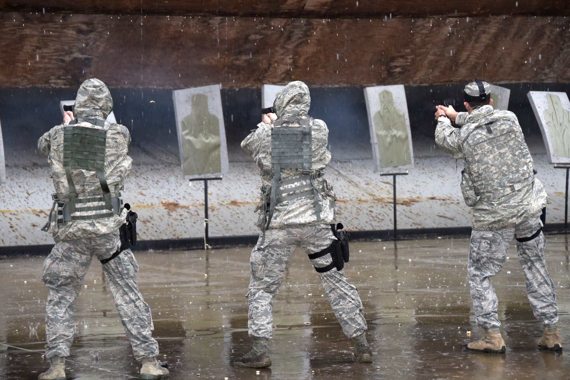 SAVANNAH CRTC, GA - Members of the 114th Security Forces Squadron shoot 9MM handguns during qualification training at the Savannah CRTC range on Feb. 4, 2016.  The rainy day didn't stop the unit members from completing their qualification training which was a part of the 114th Fighter Wings deployment to Sentry Savannah 16-1.(U.S. Air National Guard photo by Senior Master Sgt. Nancy Ausland/Released)