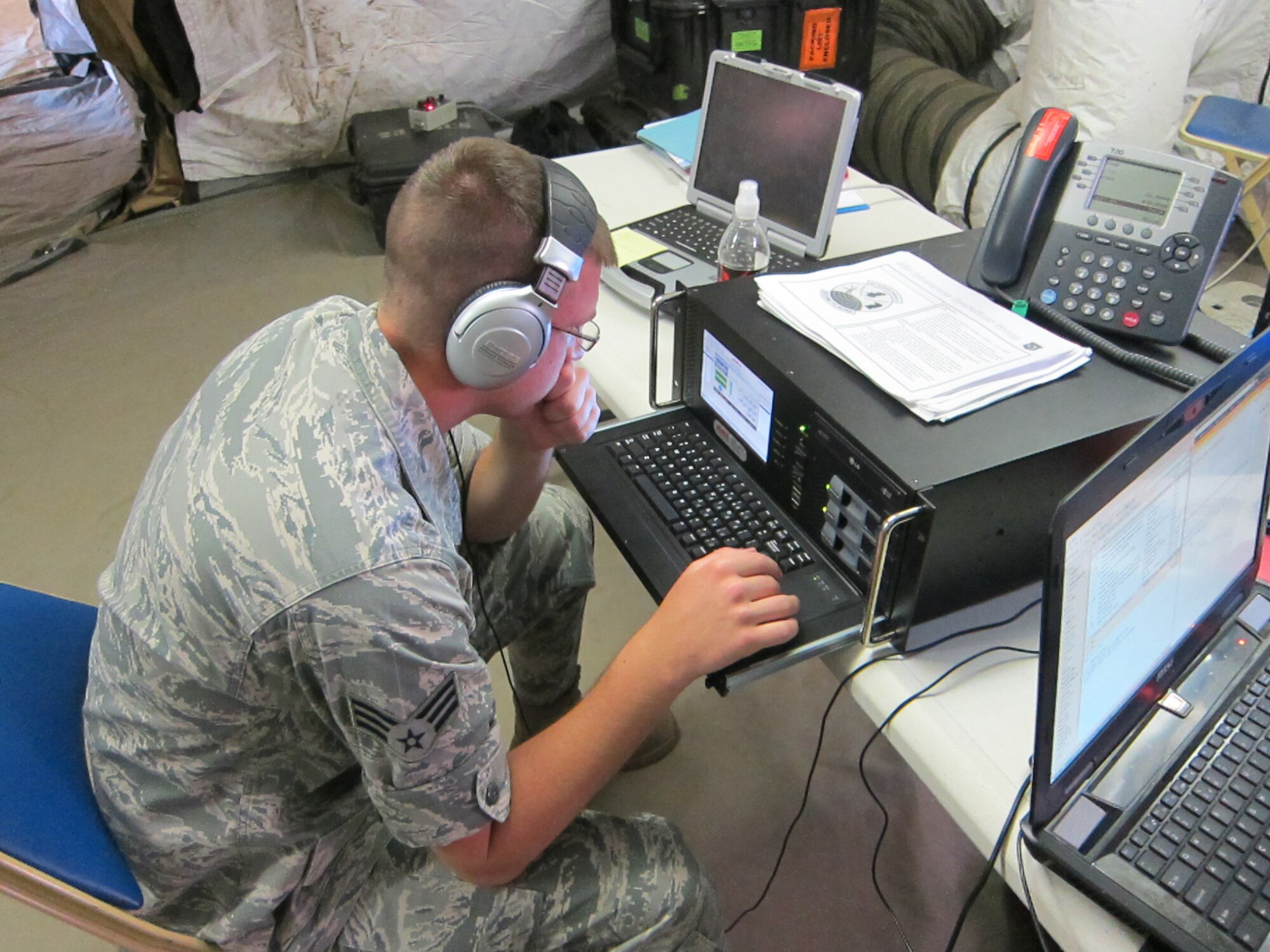 Senior Airman Donovan Mattea, 960th Network Warfare Flight, analyzes voice traffic for operations security vulnerabilities during Exercise Angel Thunder at Marine Corp Base Camp Pendleton, Calif., in June 2015. This exercise marked the first time this capability has been deployed to the field, although it has been tested during in-house exercises.  It provides near real-time feedback to our tactical partners about information being revealed that may be of intelligence value to the adversary. (U.S. Air Force courtesy photo)

