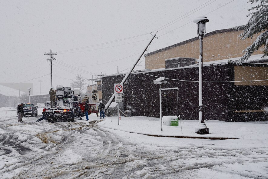 Members of the 87th CES right a fallen power pole at Joint Base McGuire-Dix-Lakehurst, N.J., Feb. 5, 2016. An early morning snowstorm produced a significant amount of snowfall, which contributed to the toppling of the power pole against building 3322 in the 108th Wing’s area of the joint base. Within a few hours, the electricians had the pole temporarily righted and the power restored to nearby buildings. The 87th CES is expecting to replace the broke power pole by the end of the day. The 87th ABW started a base-wide initiative to move all power lines underground last year and is expected to complete the initiative this spring. (U.S. Air National Guard photo by Master Sgt. Carl Clegg/Released) 