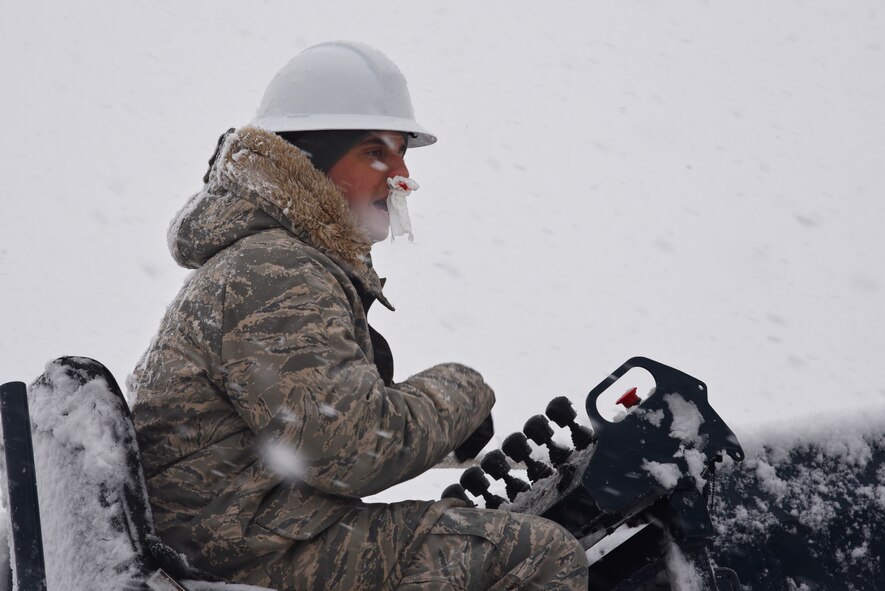 Senior Airman Francisco Villa, 87th CES works the controls of a bucket truck to right a fallen power pole at Joint Base McGuire-Dix-Lakehurst, N.J., Feb. 5, 2016. Villa suffered a minor bloody nose during the effort to right the pole. An early morning snowstorm produced a significant amount of snowfall, which contributed to the toppling of the power pole against building 3322 in the 108th Wing’s area of the joint base. Within a few hours, the electricians had the pole temporarily righted and the power restored to nearby buildings. The 87th CES is expecting to replace the broke power pole by the end of the day. The 87th ABW started a base-wide initiative to move all power lines underground last year and is expected to complete the initiative this spring. (U.S. Air National Guard photo by Master Sgt. Carl Clegg/Released) 
