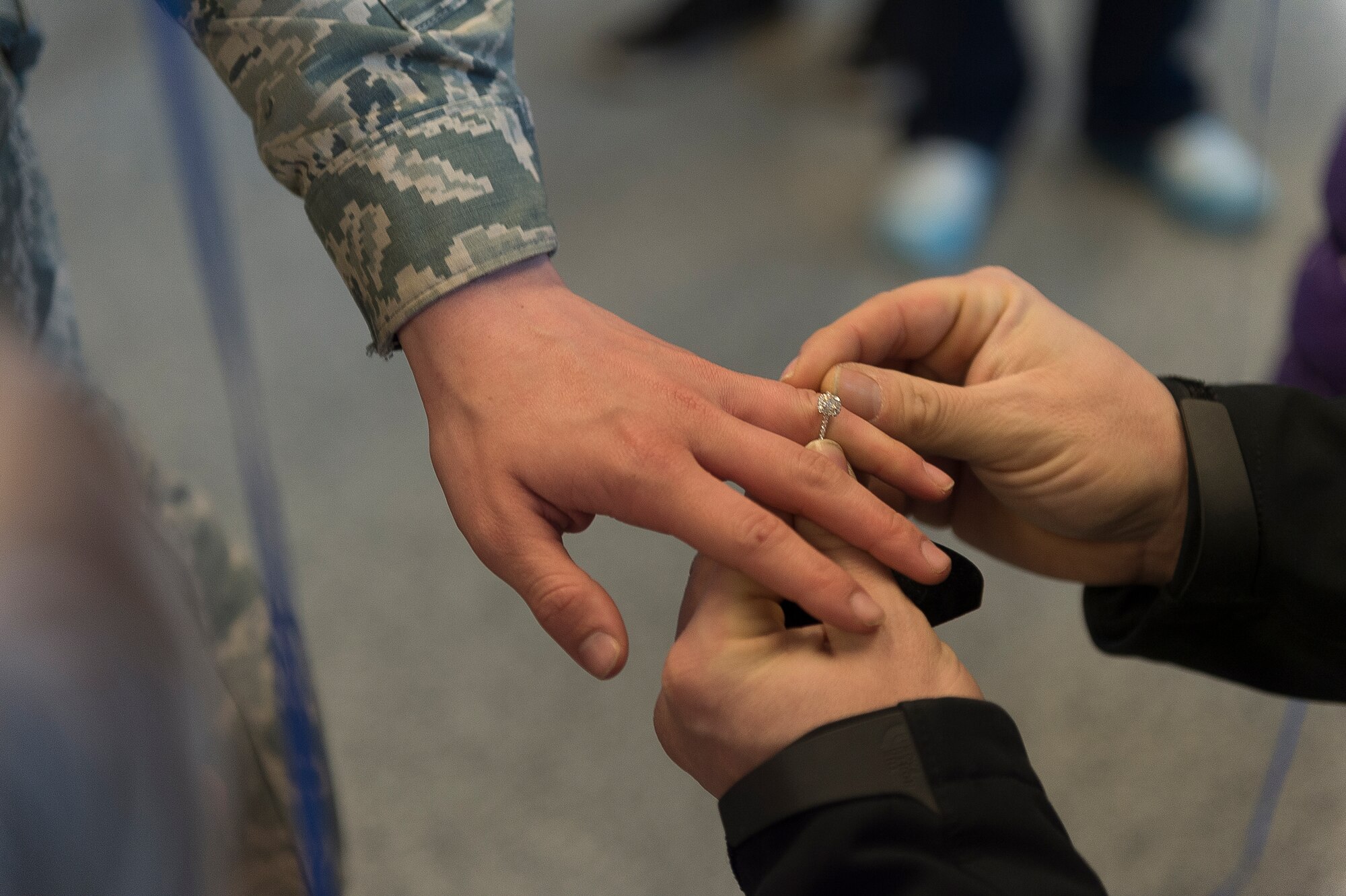 Justin Jurs surprises Airman 1st Class Amanda Lavocat, an Airman assigned to the 107th Security Forces Squadron, Niagara Falls Air Reserve Station, N.Y., by proposing to her upon her arrival home from a deployment. Lavocat was one of more than 30 Airmen from the 107th SFS to return from a six-month deployment to Southwest Asia, Feb. 4-5, 2016. (U.S. Air National Guard photo by Staff Sgt. Ryan Campbell/Released)