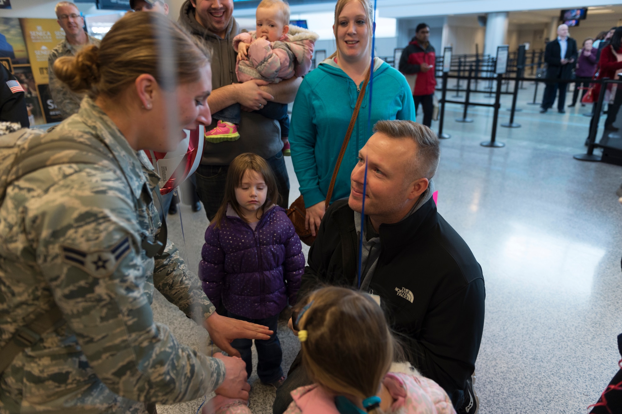 Justin Jurs surprises Airman 1st Class Amanda Lavocat, an Airman assigned to the 107th Security Forces Squadron, Niagara Falls Air Reserve Station, N.Y., by proposing to her upon her arrival home from a deployment. Lavocat was one of more than 30 Airmen from the 107th SFS to return from a six-month deployment to Southwest Asia, Feb. 4-5, 2016. (U.S. Air National Guard photo by Staff Sgt. Ryan Campbell/Released)