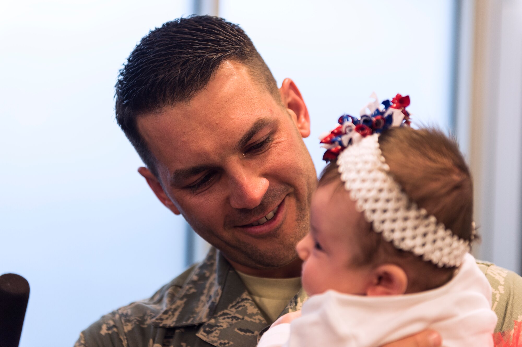 Master Sgt. Daniel Owczarczak, an Airman assigned to the 107th Security Forces Squadron, N.Y., gets to hold his newborn daughter for the first time. Owczarczak was one of more than 30 Airmen from the 107th SFS to return from a six-month deployment to Southwest Asia, Feb. 4-5, 2016. (U.S. Air National Guard photo by Staff Sgt. Ryan Campbell/Released)