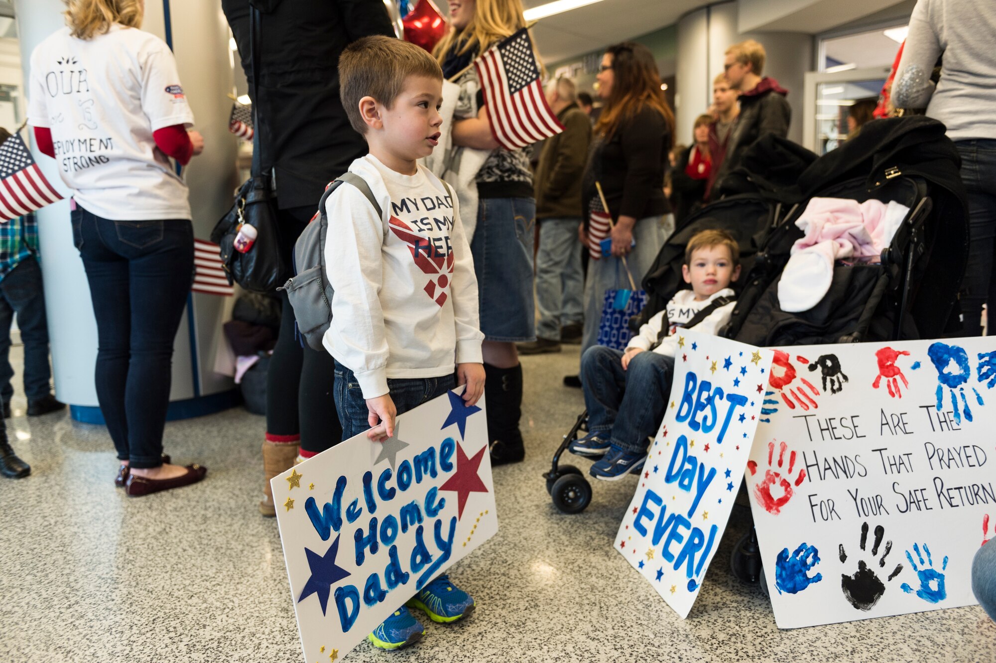 Families wait at the Buffalo International Airport as more than 30 Airmen from the 107th Security Forces Squadron, Niagara Falls Air Reserve Station, N.Y., return from a six-month deployment to Southwest Asia, Feb. 4-5, 2016. (U.S. Air National Guard photo by Staff Sgt. Ryan Campbell/Released)