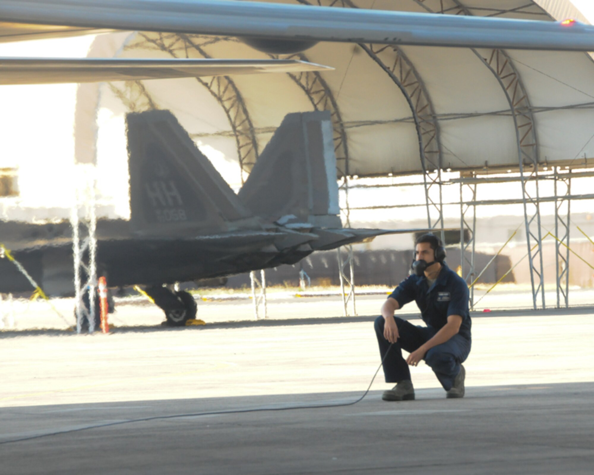A crew chief with the 477th Maintenance Squadron based out of Alaska monitors a Hawaii Air National Guard F-22 Raptor during pre-flight procedures at Joint Base Pearl Harbor-Hickam, Feb. 5, 2016. While on temporary duty in Hawaii, the 477th MXS assisted 154th MXS counterparts with the maintenance of the Hawaiian Raptors. (U.S. Air National Guard photo by Senior Airman Orlando Corpuz/released)
