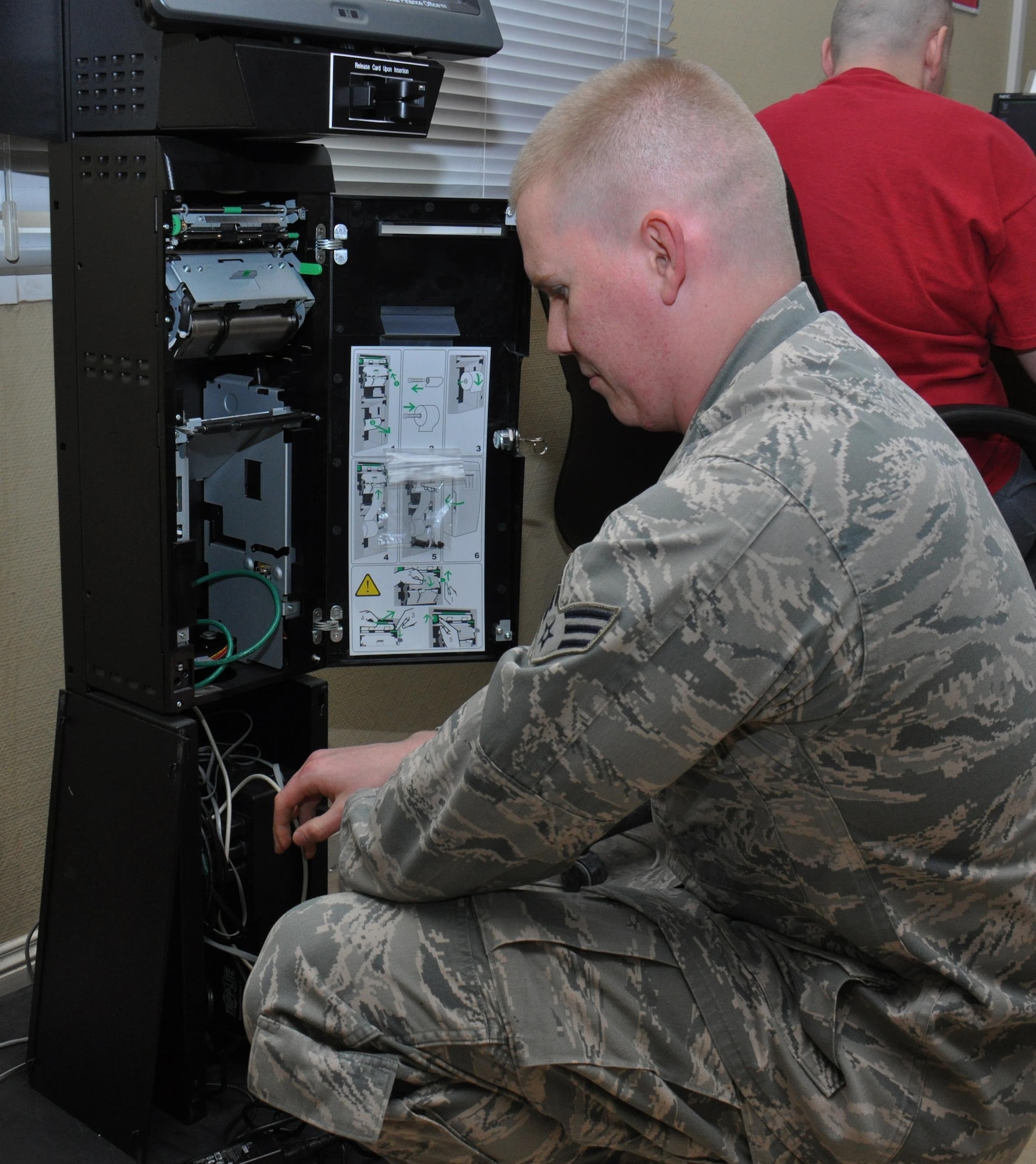 Senior Airman James Ratzlaff, 379th Expeditionary Comptroller Squadron customer service technician from Spokane, Washington, performs maintenance on an Eagle Cash kiosk at Al Udeid Air Base, Qatar, Jan. 24. The 379 ECPTS manages 10 kiosks at AUAB. The eagle cash card program enables deployed service members to make purchases through a vareity of vendors on base. Ratzlaff said he enjoys his job and assists approximately 430 customers a week. The 379 ECPTS provides a vareity of services including financial analysis, military pay, travel and Savings Deposit Program assistance. (U.S. Air Force photo by Tech. Sgt. James Hodgman/Released)