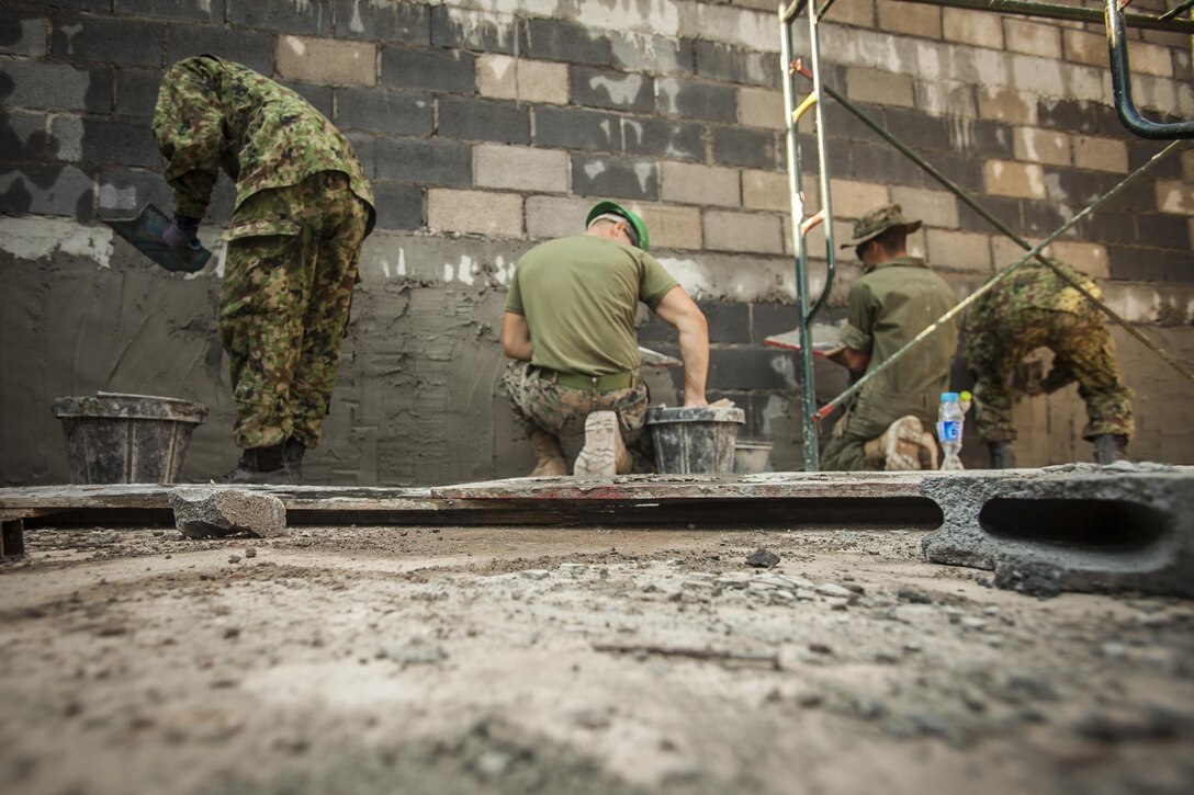 Service members with the Royal Thai Navy, Japan Ground Self-Defense Force and U.S. Marines with Marine Wing Support Squadron 171 help build a multipurpose room at the Ban Cham Kho School, in Rayong, Thailand, exercise Cobra Gold, Feb. 4, 2016. Cobra Gold 2016, in its 35th iteration, includes a specific focus on humanitarian civic action, community engagement and medical activities conducted during the exercise to support the needs and humanitarian interests of civilian populations around the region.