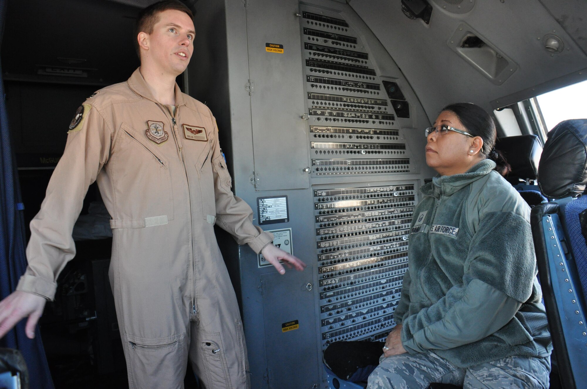 Capt. Brian, an 816th Expeditionary Airlift Squadron C-17 Globemaster III pilot, gives Master Sgt. Janine Obando, 379th Air Expeditionary Wing Equal Opportunity Office director, a tour of a C-17 Globemaster III Jan. 29 at Al Udeid Air Base, Qatar. As the 379 AEW's EO director, Obando is required to visit with commanders and service members in their work centers to ensure they know the services the EO office provides. Brian is an aircraft commander deployed from Dover Air Force Base, Delaware. (U.S. Air Force photo by Tech. Sgt. James Hodgman/Released)