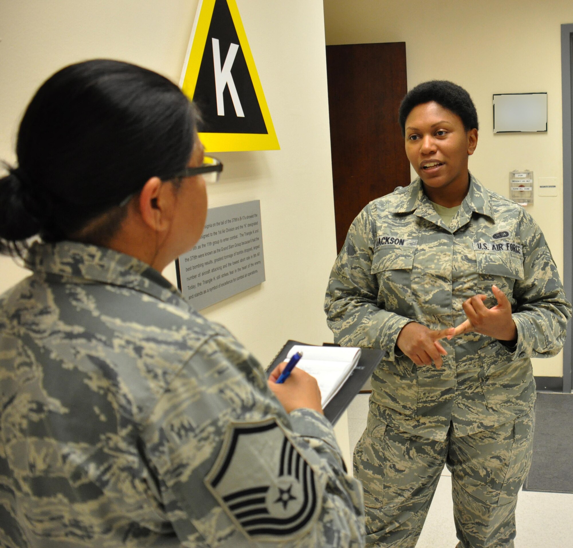 Staff Sgt. Yolanda Jackson, 379th Air Expeditionary Wing Protocol noncommissioned officer in charge from Chicago, meets with Master Sgt. Janine Obando, 379 AEW Equal Opportunity director from Ewa, Hawaii, at the Wing Operations Center at Al Udeid Air Base, Qatar, Jan. 21. Obando said it's important for her to meet with service members across AUAB to foster trust between units and the EO office. Jackson and Obando discussed different aspects of the protocol mission during the meeting. Photo altered for security purposes. (U.S. Air Force photo by Tech. Sgt. James Hodgman/Released)