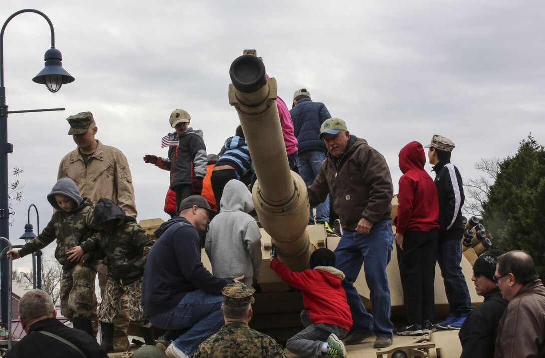 Local residents explore an M1A1 Abrams tank following the 2nd Marine Division’s 75th anniversary parade in downtown Jacksonville, N.C., Feb. 6, 2016. The celebration serves as a time to remember the Marines and sailors who served and continue to serve in 2nd Marine Division, while thanking the local community for their support. (U.S. Marine Corps photo by Cpl. Paul S. Martinez/Released)