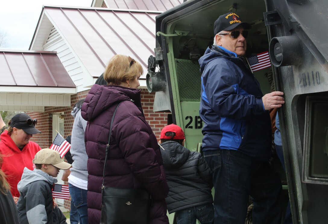 Local residents explore an assault amphibious vehicle following the 2nd Marine Division’s 75th anniversary parade in downtown Jacksonville, N.C., Feb. 6, 2016. The celebration serves as a time to remember the Marines and sailors who served and continue to serve in 2nd Marine Division, while thanking the local community for their support. (U.S. Marine Corps photo by Cpl. Paul S. Martinez/Released)