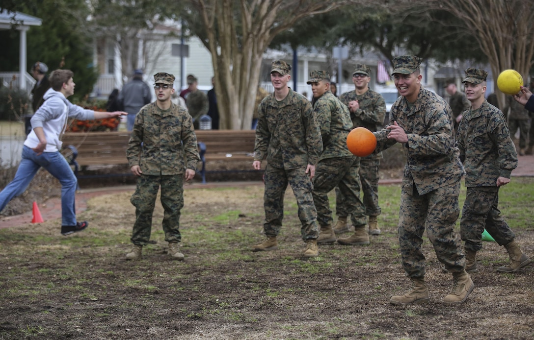 Corporal Caleb Sevier, a combat engineer with 2nd Combat Engineer Battalion, 2nd Marine Division, plays a game of dodgeball alongside Marines and community members following the Division’s 75th anniversary parade in downtown Jacksonville, N.C., Feb. 6, 2016. The celebration serves as a time to remember the Marines and sailors who served and continue to serve in 2nd Marine Division, while thanking the local community for their support. (U.S. Marine Corps photo by Cpl. Paul S. Martinez/Released)