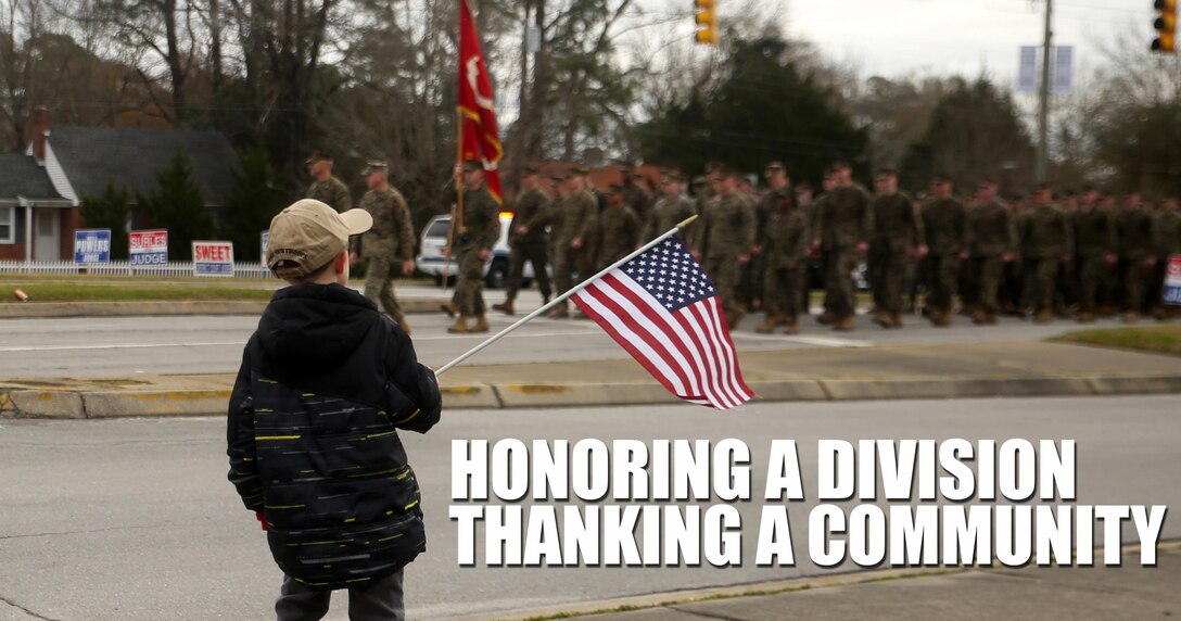 A young boy watches as Marines and sailors with 2nd Marine Division march by in the unit’s 75th anniversary parade in downtown Jacksonville, N.C., Feb. 6, 2016. The celebration serves as a time to remember the Marines and sailors who served and continue to serve in 2nd Marine Division, while thanking the local community for their support. (U.S. Marine Corps photo by Cpl. Joey Mendez/Released)