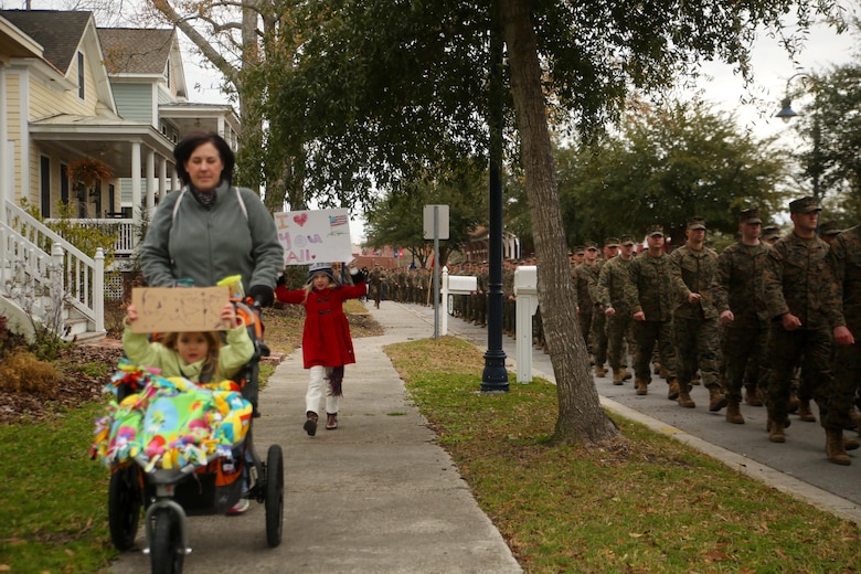 A young girl displays a sign to show support for 2nd Marine Division during the unit’s 75th anniversary parade in downtown Jacksonville, N.C., Feb. 6, 2016. The celebration serves as a time to remember the Marines and sailors who served and continue to serve in 2nd Marine Division, while thanking the local community for their support. (U.S. Marine Corps photo by Cpl. Joey Mendez/Released)