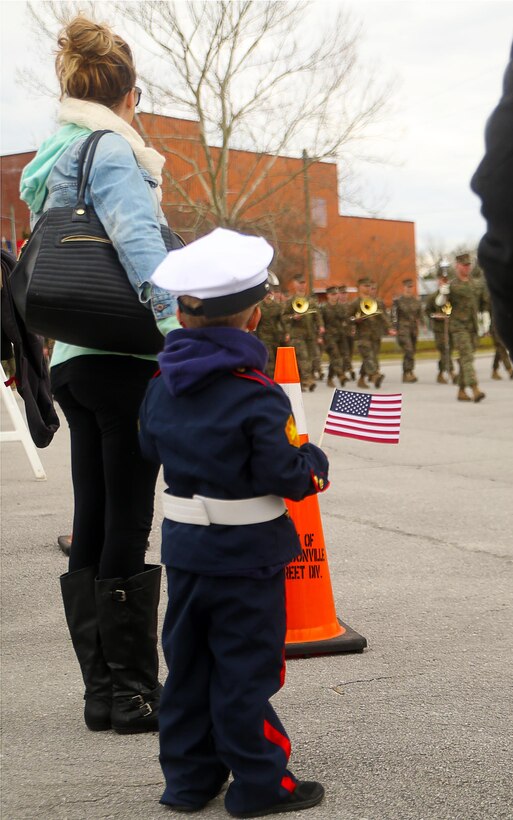 A young boy watches as Marines with 2nd Marine Division march in the unit’s 75th anniversary parade in downtown Jacksonville, N.C., Feb. 6, 2016. The celebration serves as a time to remember the Marines and sailors who served and continue to serve in 2nd Marine Division, while thanking the local community for their support. (U.S. Marine Corps photo by Cpl. Joey Mendez/Released)