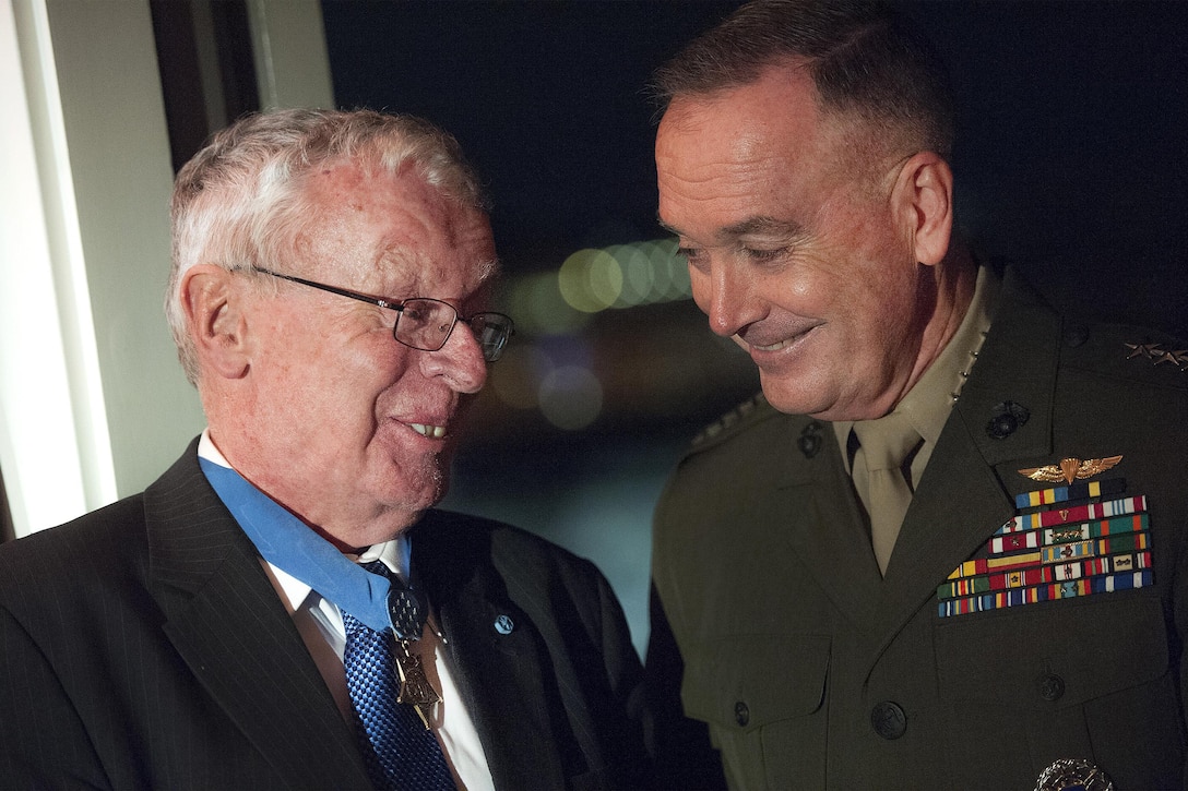 Marine Corps Gen. Joseph F. Dunford Jr., right, chairman of the Joint Chiefs of Staff, speaks with a Medal of Honor recipient at the USO 75th anniversary reception in Washington, D.C., Feb. 4, 2016. DoD photo by Navy Petty Officer 2nd Class Dominique A. Pineiro