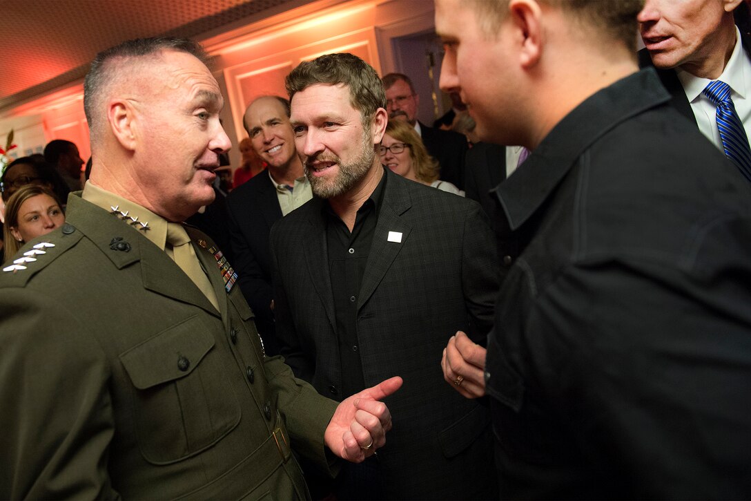 Marine Corps Gen. Joseph F. Dunford Jr., left, chairman of the Joint Chiefs of Staff, speaks with country music singer and Army veteran Craig Morgan, center, at the USO 75th anniversary reception in Washington, D.C., Feb. 4, 2016. DoD photo by Navy Petty Officer 2nd Class Dominique A. Pineiro
