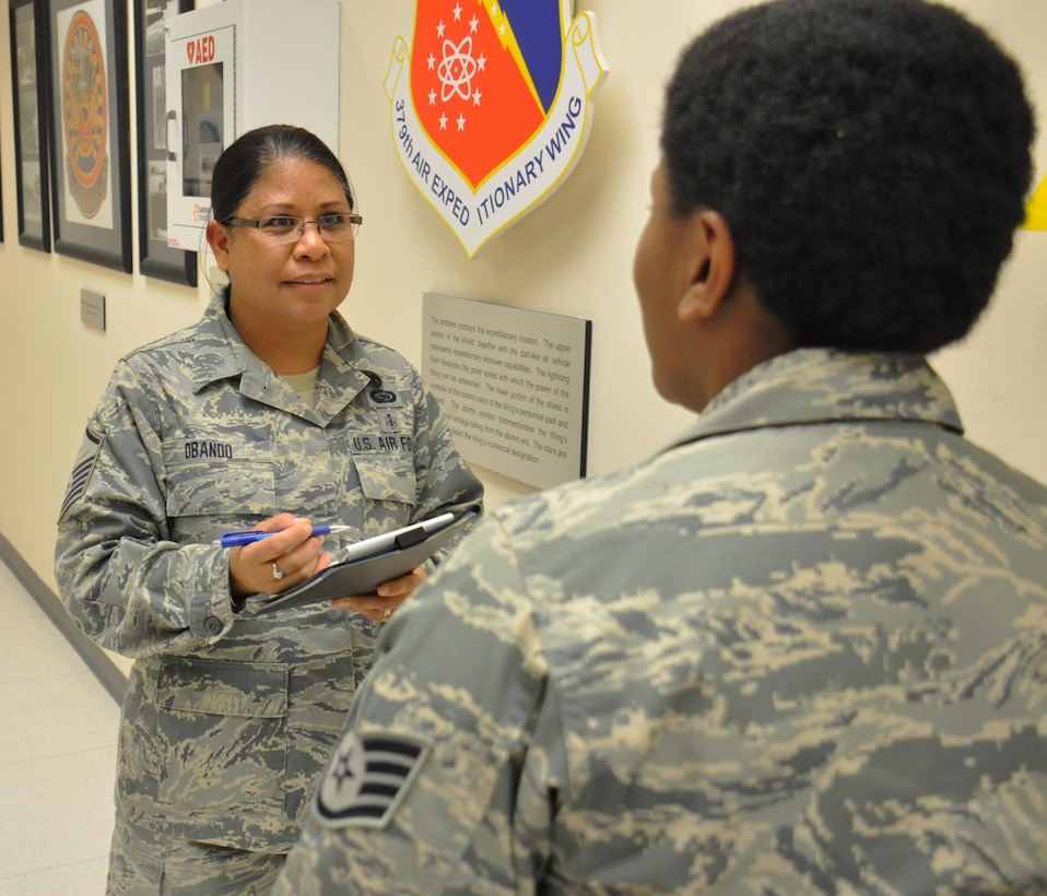 Air Force Master Sgt. Janine Obando, the 379th Air Expeditionary Wing’s equal opportunity director, left, meets with Air Force Staff Sgt. Yolanda Jackson, the noncommissioned officer in charge of 379th AEW protocol on Al Udeid Air Base, Qatar, Jan. 21, 2016. Obando, who hails from Ewa, Hawaii, said it's important to meet with service members to foster trust between units and the EO office. Air Force photo by Tech. Sgt. James Hodgman