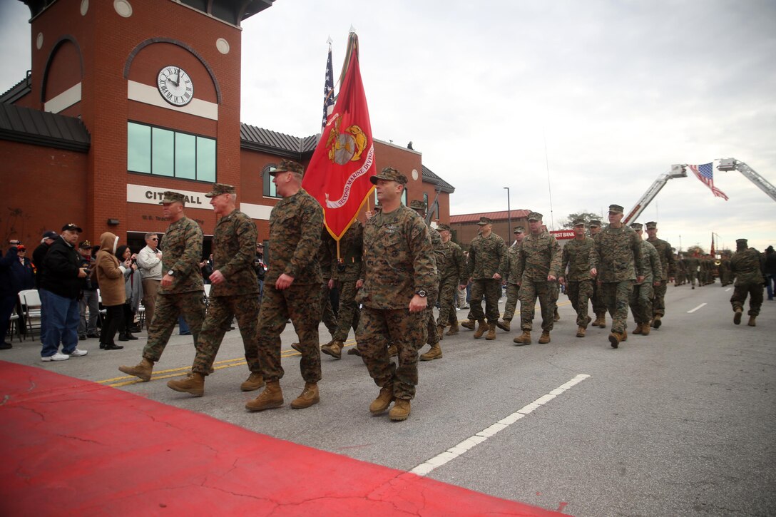 Maj. Gen. Brian D. Beaudreault, commanding general of 2nd Marine Division, flanked by fellow leaders of the unit, marches past City Hall during the unit’s 75th anniversary parade in downtown Jacksonville, N.C., Feb. 6, 2016. The celebration serves as a time to remember the Marines and sailors who served and continue to serve in 2nd Marine Division, while thanking the local community for their support. (U.S. Marine Corps photo by Cpl. Joey Mendez/Released)