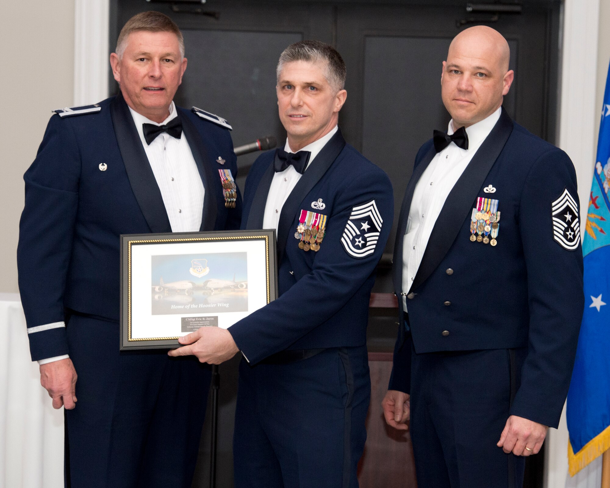 Col. Doug Schwartz, 434th Air Refueling Wing commander, and Chief Master Sgt. Robert Herman, 434th Air Refueling Wing command chief, present retired Chief Master Sgt. Eric Jaren a plaque during the 2015 annual awards recognition banquet in Kokomo Ind., Feb. 6, 2016.  During the event, Jaren applauded the winners for their hard work and commitment. (U.S. Air Force photo/Senior Airman Andrew Crawford) Token of appreciation 