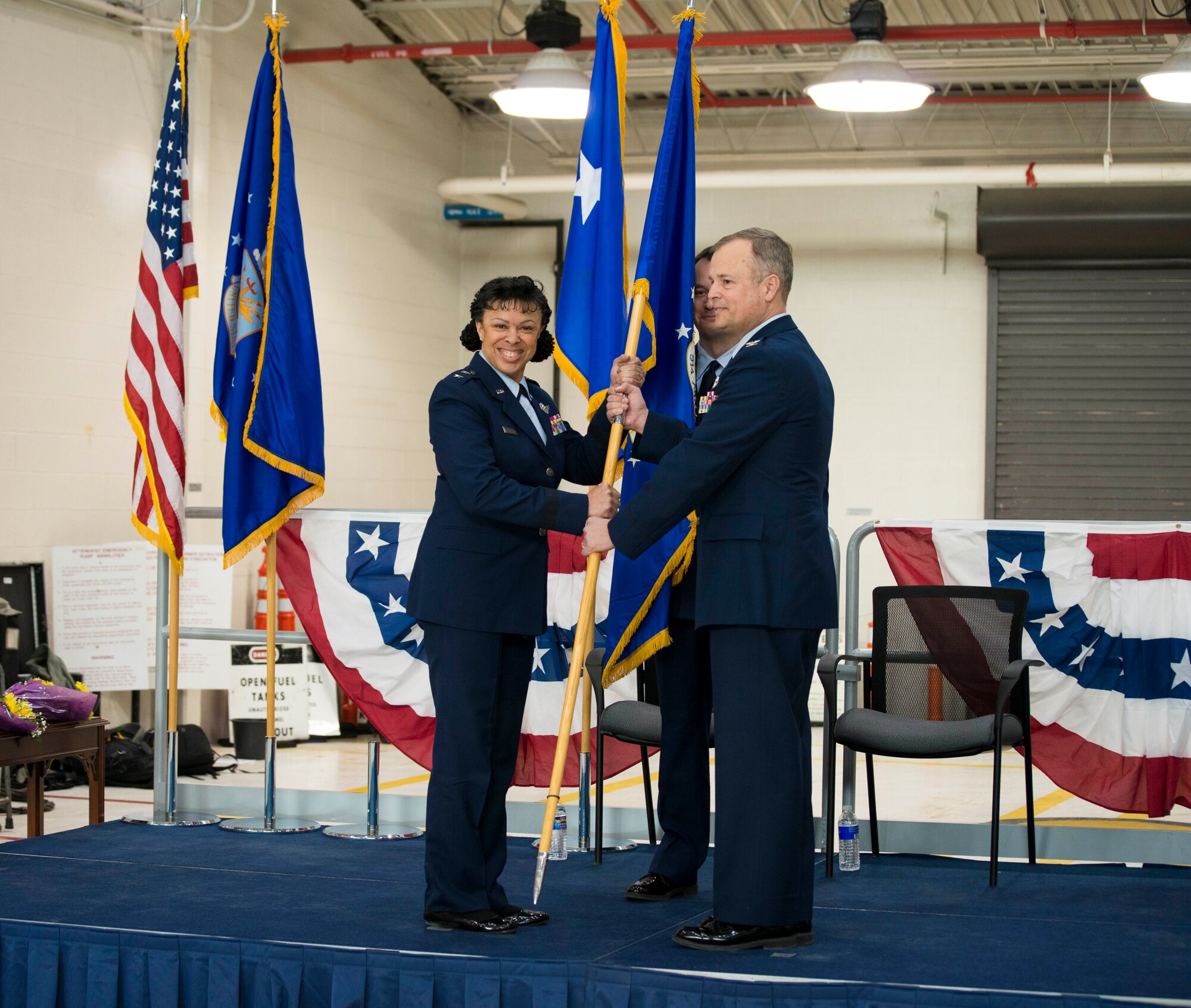 Major General Stayce D. Harris, Commander of the 22nd Air Force, Dobbins Air Reserve Station, GA, hands off the Wing flag to Colonel Brian S. Bowman as he assumes command of the 914th Airlift Wing, Niagara Falls Air Reserve Station, N.Y., February 6, 2016. (U.S. Air Force photo by Tech. Sgt. Stephanie Sawyer)  