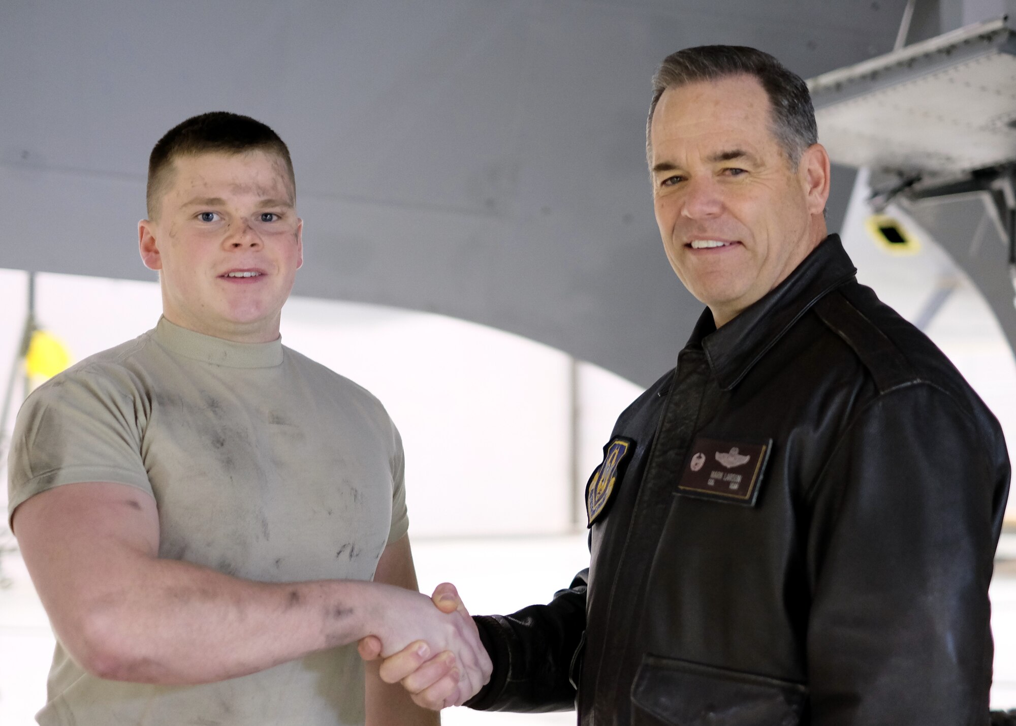 Col. Mark S. Larson, right, 931st Air Refueling Group commander, congratulates Senior Airman Josh Simmons, 931st Maintenance Squadron crew chief, for his performance during a Unit Training Assembly Feb. 7, 2016, at McConnell Air Force Base, Kan. Larson met with the unit to present a coin to Senior Airman Josh Simmons in appreciation of his performance. (U.S. Air Force photo by Senior Airman Preston Webb)