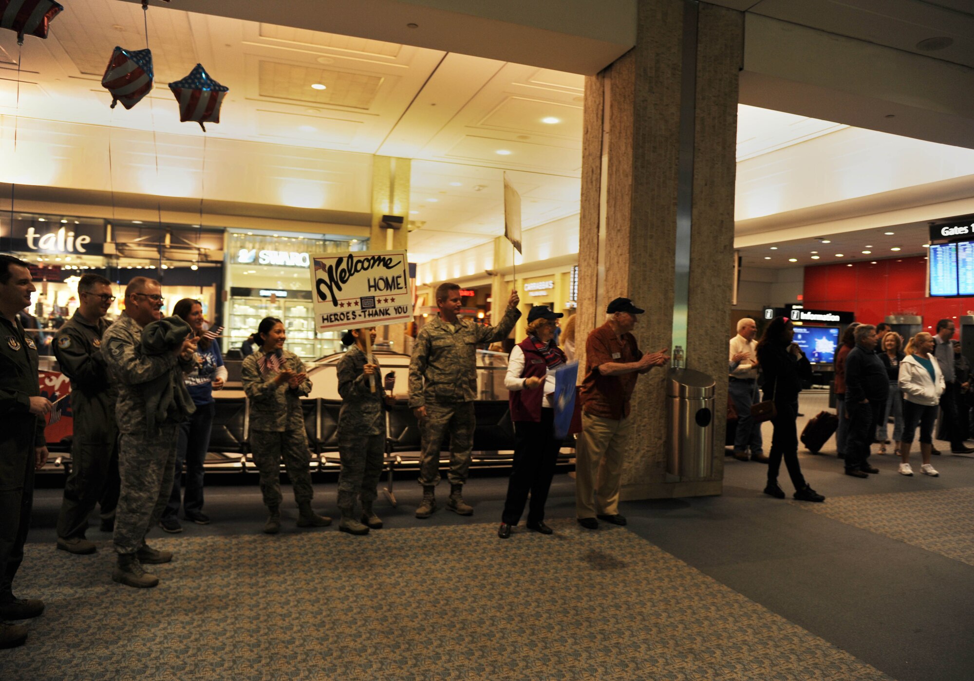 Members of the 45th Aeromedical Evacuation Squadron and families await the arrival of their loved ones during a redeployment on Feb. 5, 2016 at Tampa International Airport. Personnel arrived after serving four months overseas, assisting injured service men and women. (U.S. Air Force photo by Tech. Sgt. Peter Dean) 