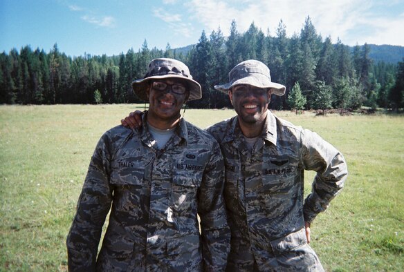 Senior Airman Cody Thaler, 114th Operations Intelligence specialist, poses with Capt. Ali Chinisaz, during field training at the combat survival training course in Colville National Forest, Wash., July 22, 2013. Thaler is pursuing an Air Force active duty position as a Survival, Evasion, Resistance and Escape (SERE) specialist. (Courtesy photo/Released)