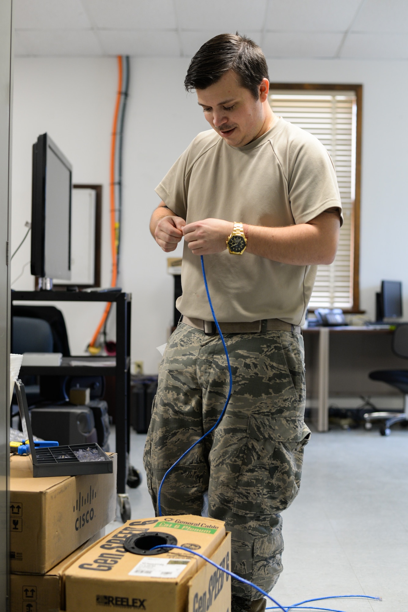 Technical Sgt. Timothy Dohack, the 131st Communications Flight noncommissioned officer in charge of infrastructure and cyber transport makes new lines of 10-foot category 6 Ethernet cables at Jefferson Barracks, Missouri, February 2, 2016. The category 6 Ethernet cables are being used in the buildings of Jefferson Barracks to ensure fast internet connections. (U.S. Air National Guard photo by Staff Sgt. Brittany Cannon)