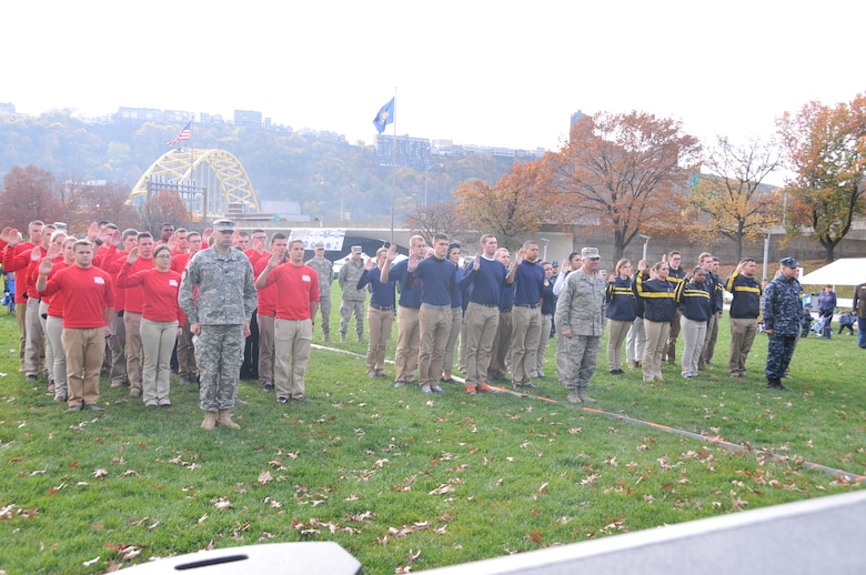 Dozens of recruits, including 15 from the 171st Air Refeuling Wing, engage in a joint service mass swearing in ceremony. The Pennsylvania National Guard joined with the Pennsylvania Department of Conservation of Natural Resources' Point State Park and the Association of the United States Army to organize Steel City Salutes the Troops, Pittsburgh, Nov. 7, 2015. (U.S. Air National Guard Photo by Staff Sgt. Ryan Conley)