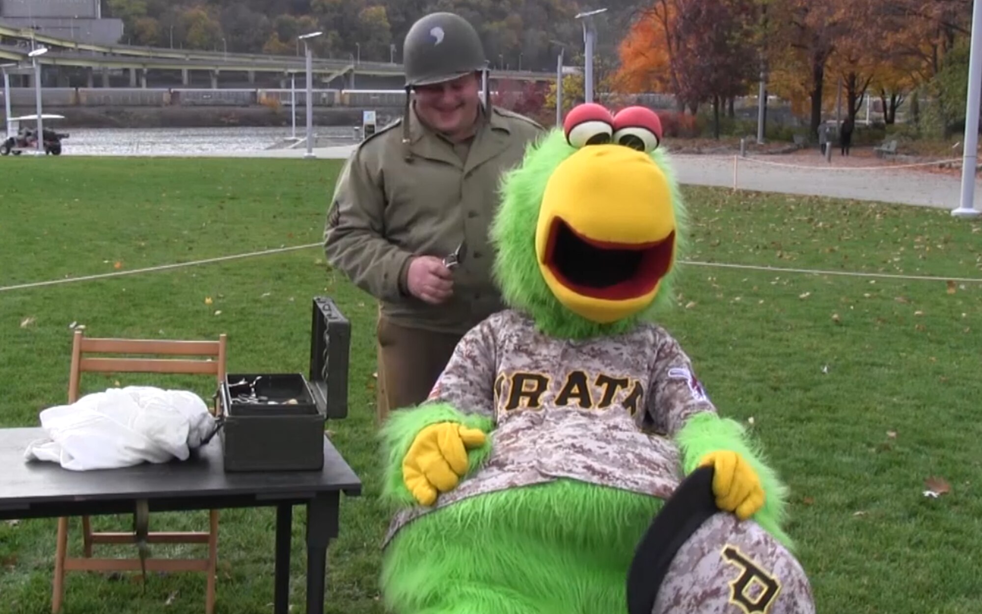 The Pirate Parrot gets a trim and a shave by a World War II field barber. The Pennsylvania National Guard joined with the Pennsylvania Department of Conservation of Natural Resources' Point State Park and the Association of the United States Army to organize Steel City Salutes the Troops, Pittsburgh, Nov. 7, 2015.  (U.S. Air National Guard Photo by Staff Sgt. Ryan Conley)
