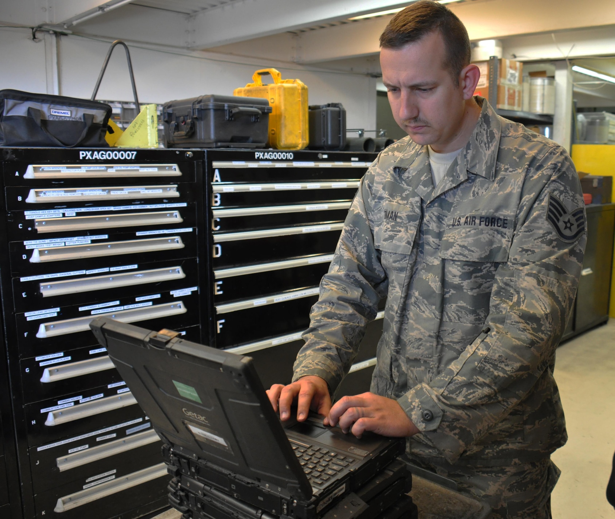 Staff Sgt. Kenneth Roman, 379th Expeditionary Maintenance Squadron Aerospace Ground Equipment Flight journeyman from Charlotte, North Carolina, conducts a check of one of the flight’s computers inside the AGE facility at Al Udeid Air Base, Qatar, Feb. 4. The flight uses computers to reference operating instructions. Roman is responsible for nearly 700 tools and parts including hammers, sockets, drills and computers. The AGE Flight maintains tools and equipment valued at $32 million. (U.S. Air Force photo by Tech. Sgt. James Hodgman/Released)