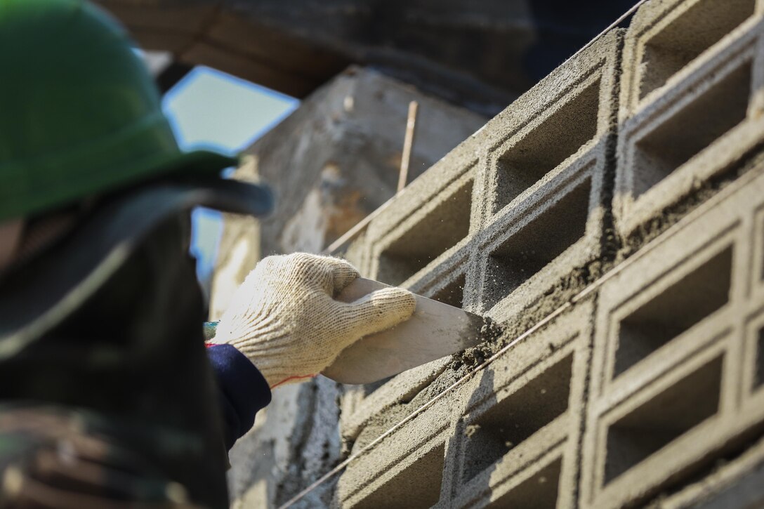 A service member from the Royal Thai Armed Forces helps build a community center at the Ban Sa Yai School, in Trat, Thailand, during exercise Cobra Gold, Feb. 3, 2016.  Cobra Gold 2016, in its 35th iteration, includes a specific focus on humanitarian civic action, community engagement, and medical activities conducted during the exercise to support the needs and humanitarian interests of civilian populations around the region.