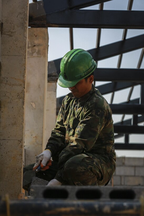 A service member from the Royal Thai Armed Forces helps build a community center at the Ban Sa Yai School in Trat, Thailand, during exercise Cobra Gold, Feb. 3, 2016.  Cobra Gold 2016, in its 35th iteration, includes a specific focus on humanitarian civic action, community engagement, and medical activities conducted during the exercise to support the needs and humanitarian interests of civilian populations around the region. 